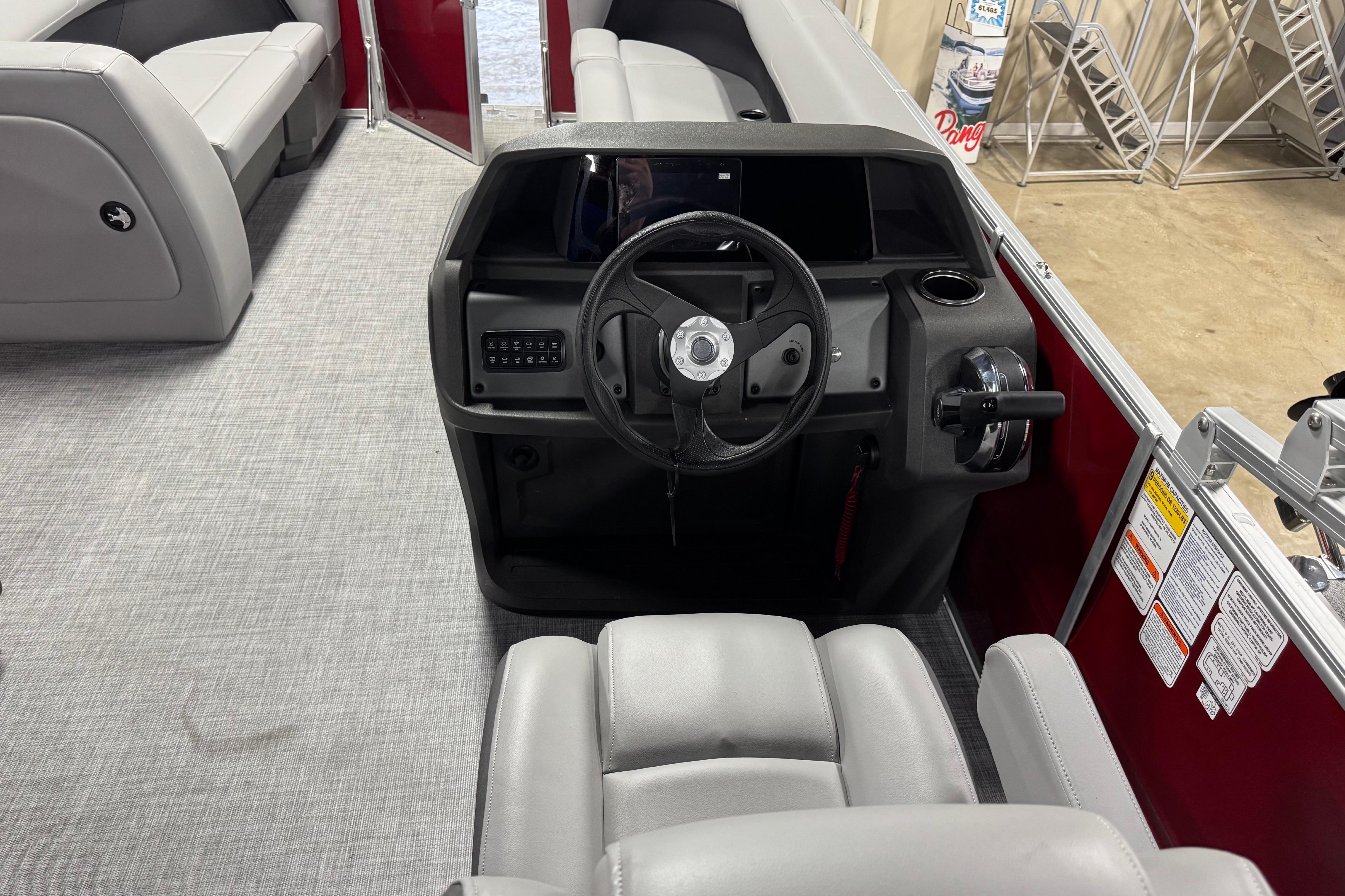 2026 Sun Tracker Party Barge 18 DLX interior with steering console and seating.