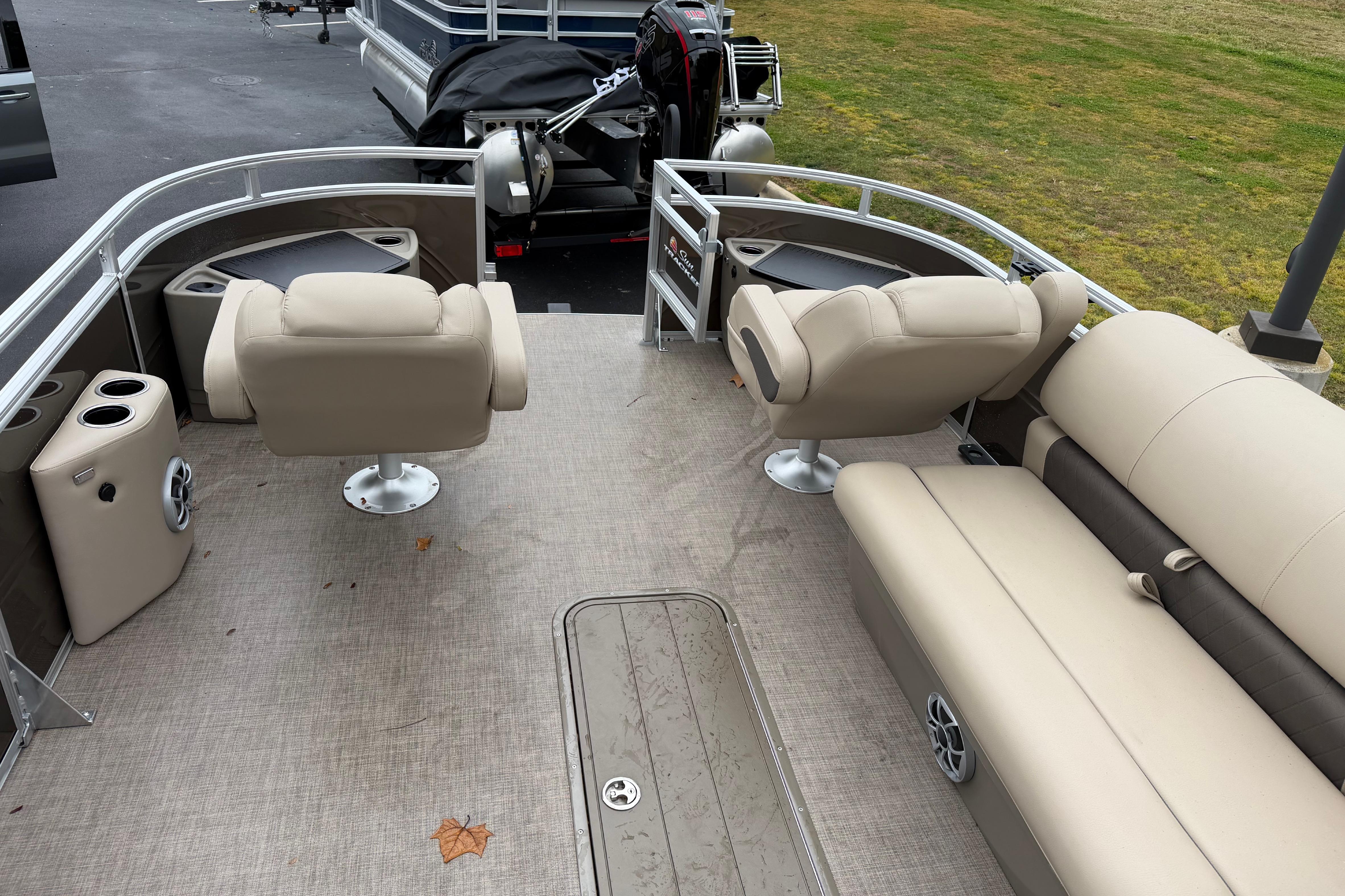 2025 Sun Tracker Sportfish 24 XP3 pontoon boat interior with beige seating and spacious layout.
