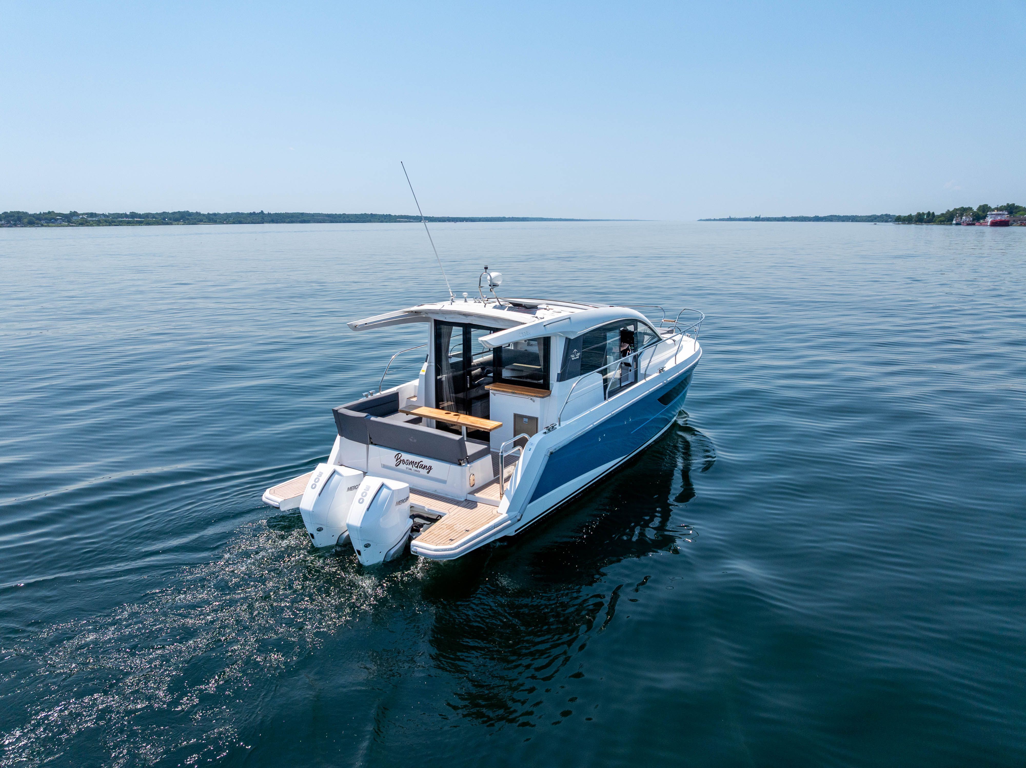 Sealine C335V 2023 on calm water with clear skies.