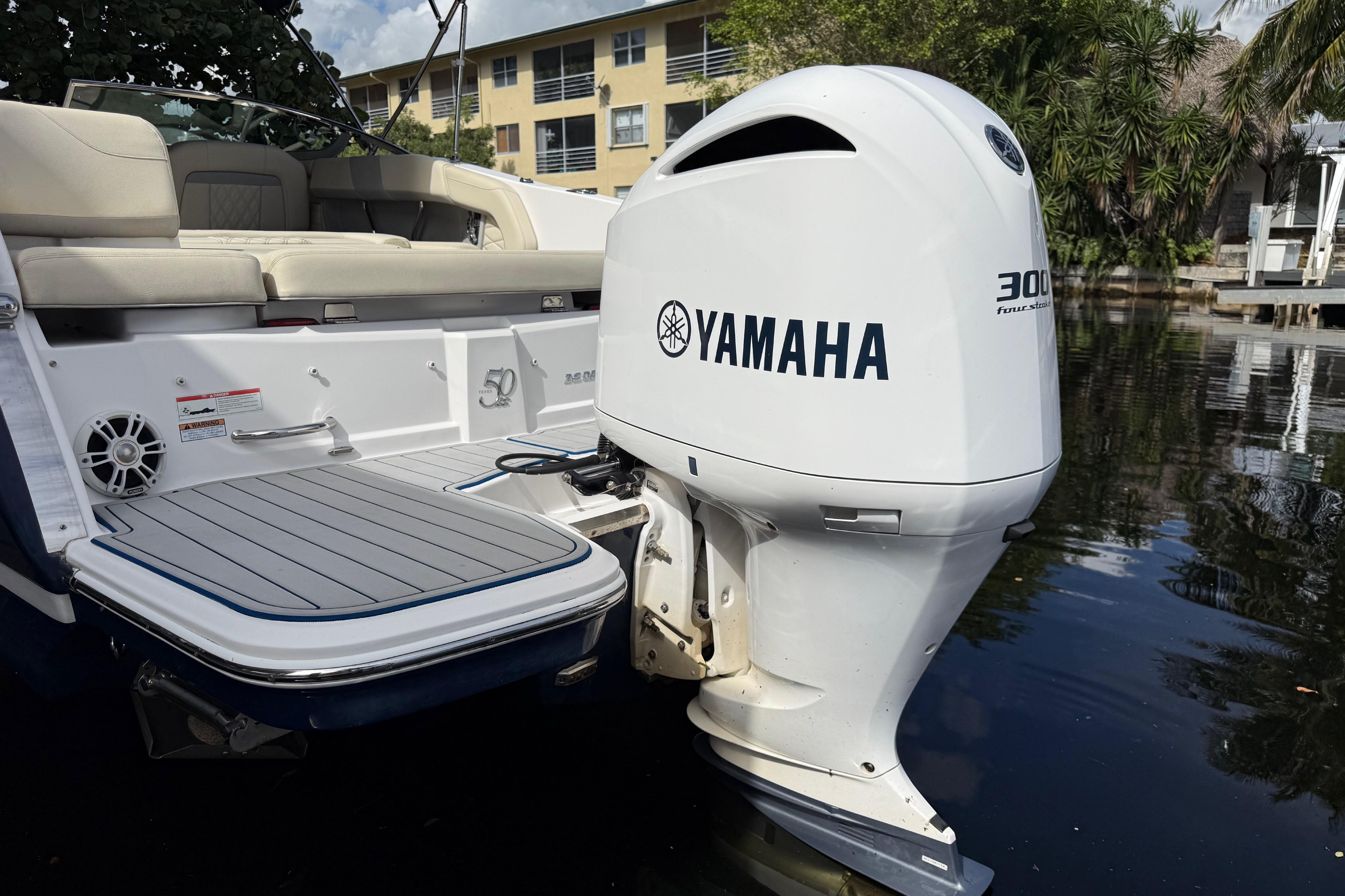 2021 Regal 26 OBX boat with Yamaha 300 outboard motor on calm water.
