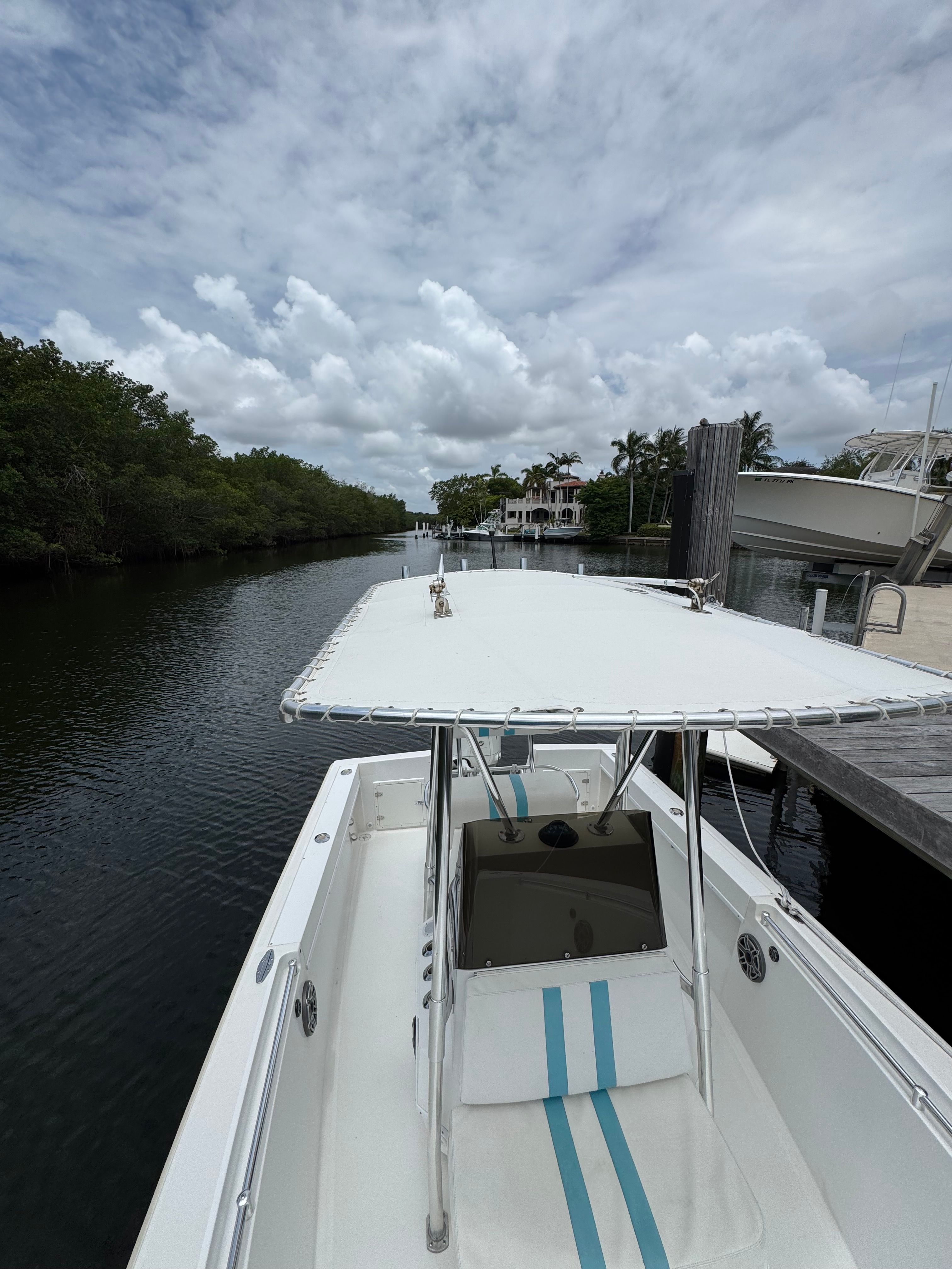 2004 Contender 21 on a calm canal with a cloudy sky.
