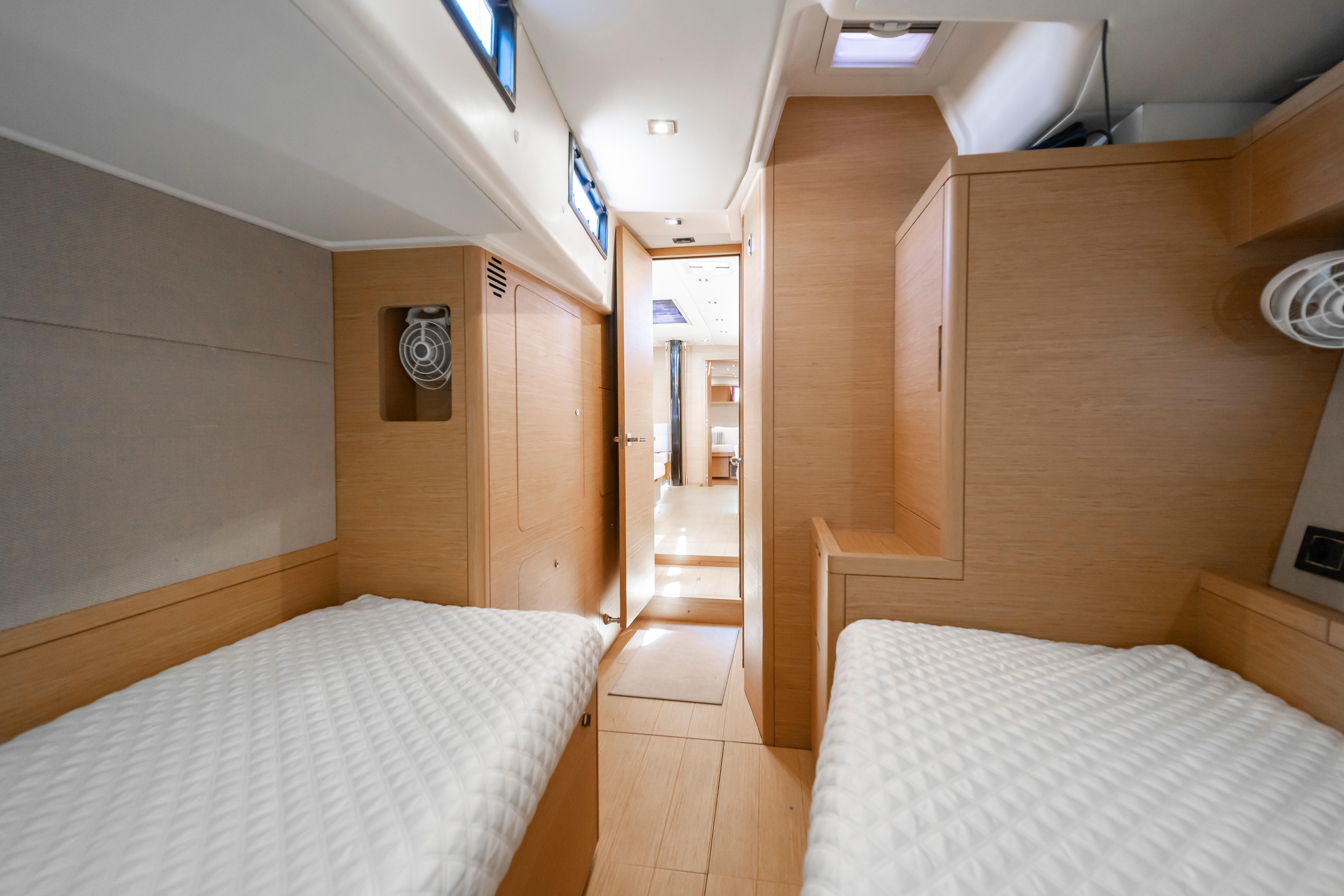 Interior of 2016 Grand Soleil 58 yacht with twin beds and wooden finish.