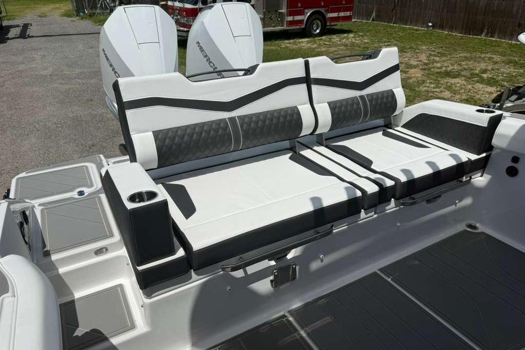 Luxury seating on 2026 Monterey Elite 30 OB boat, featuring sleek design and dual outboard engines.