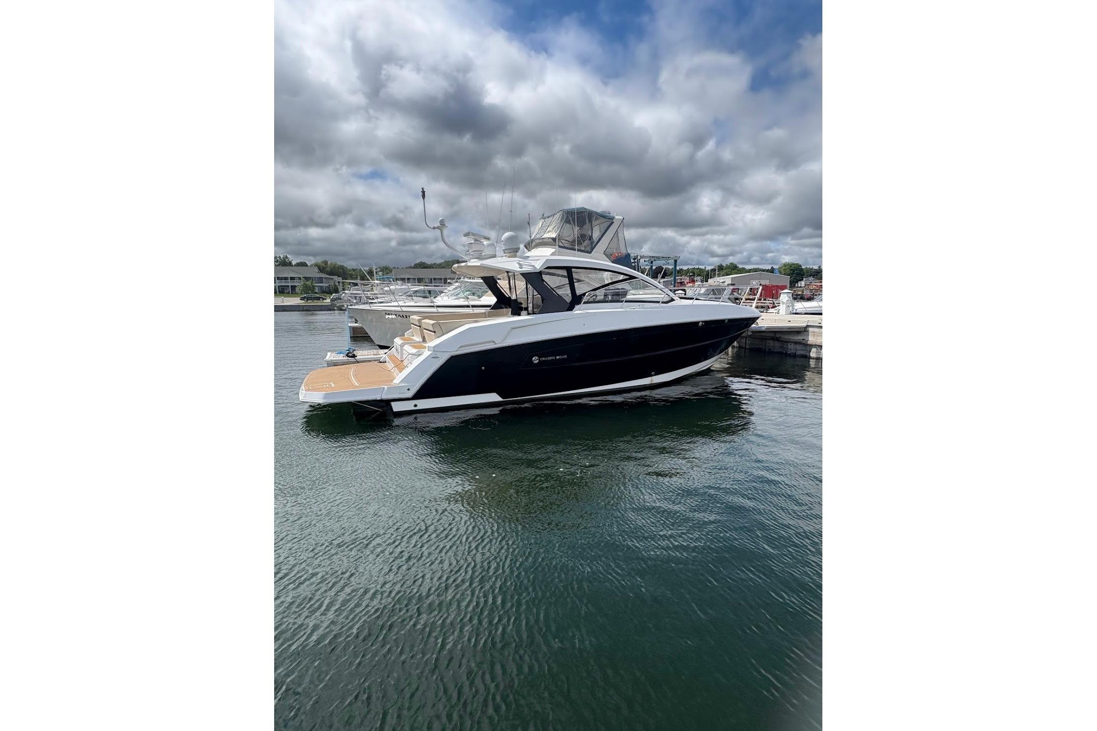 2017 Cruisers Yachts 39 Express Coupe docked on a cloudy day.