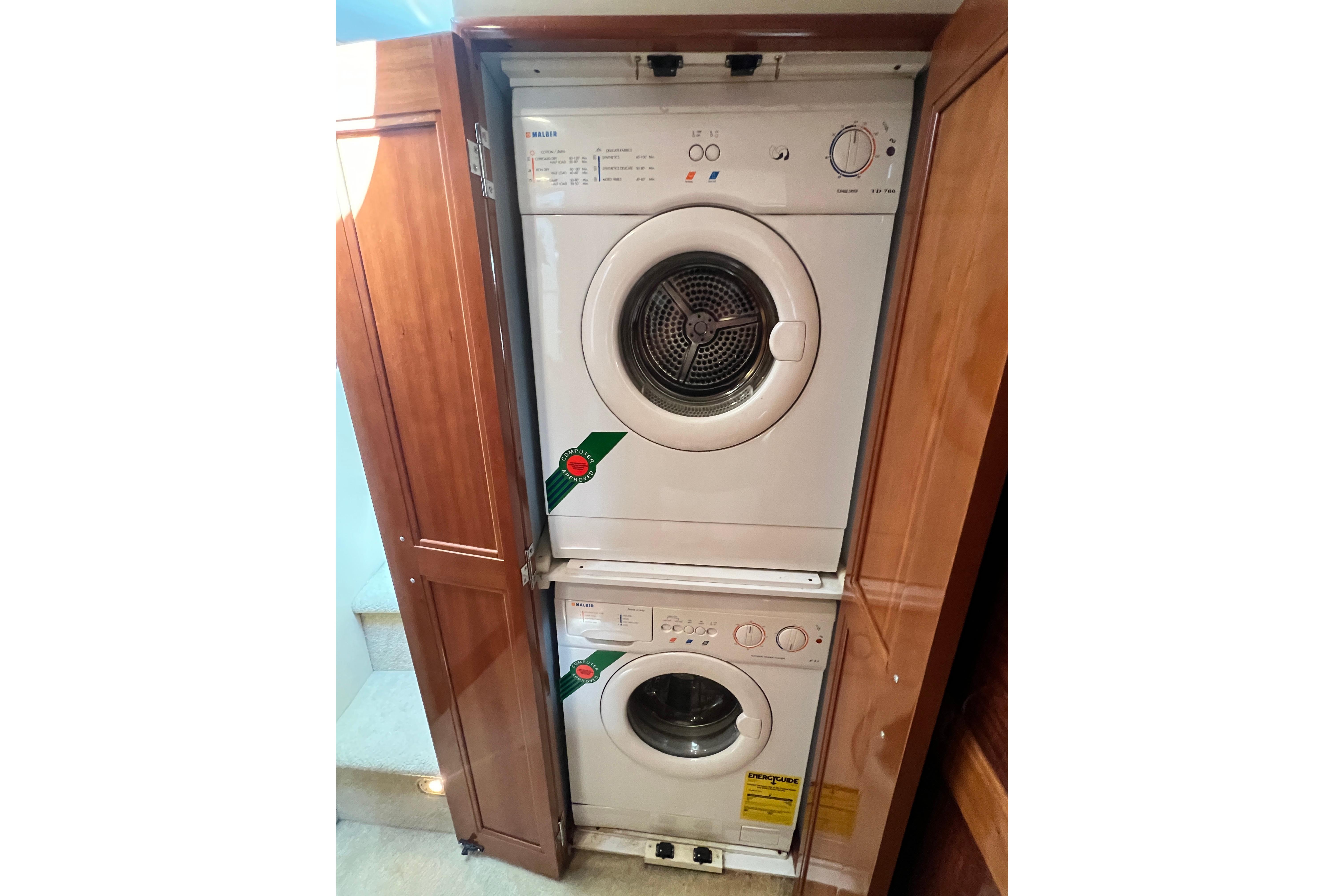 Stacked washer and dryer in 2003 Carver 450 Voyager Pilothouse laundry area.