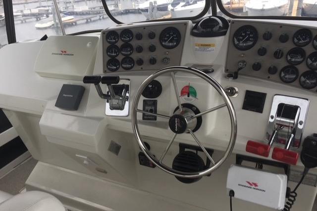 Cockpit of 1997 Carver 400 Cockpit Motor Yacht with steering wheel and control panel.