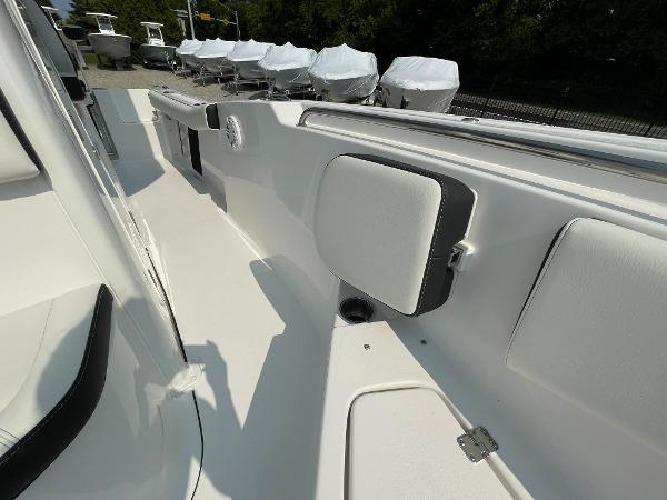 2025 Tidewater 232 CC Adventure boat interior with sleek white seating and storage compartments.