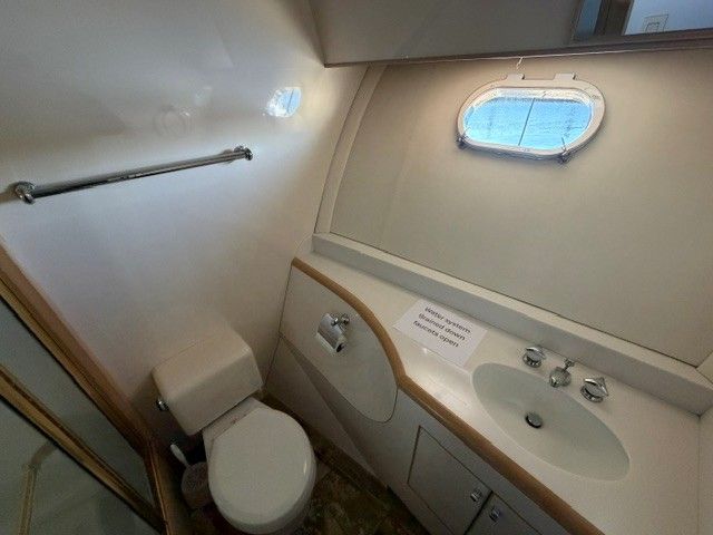 Bathroom on a 1990 Custom MOTOR YACHT with sink and toilet.
