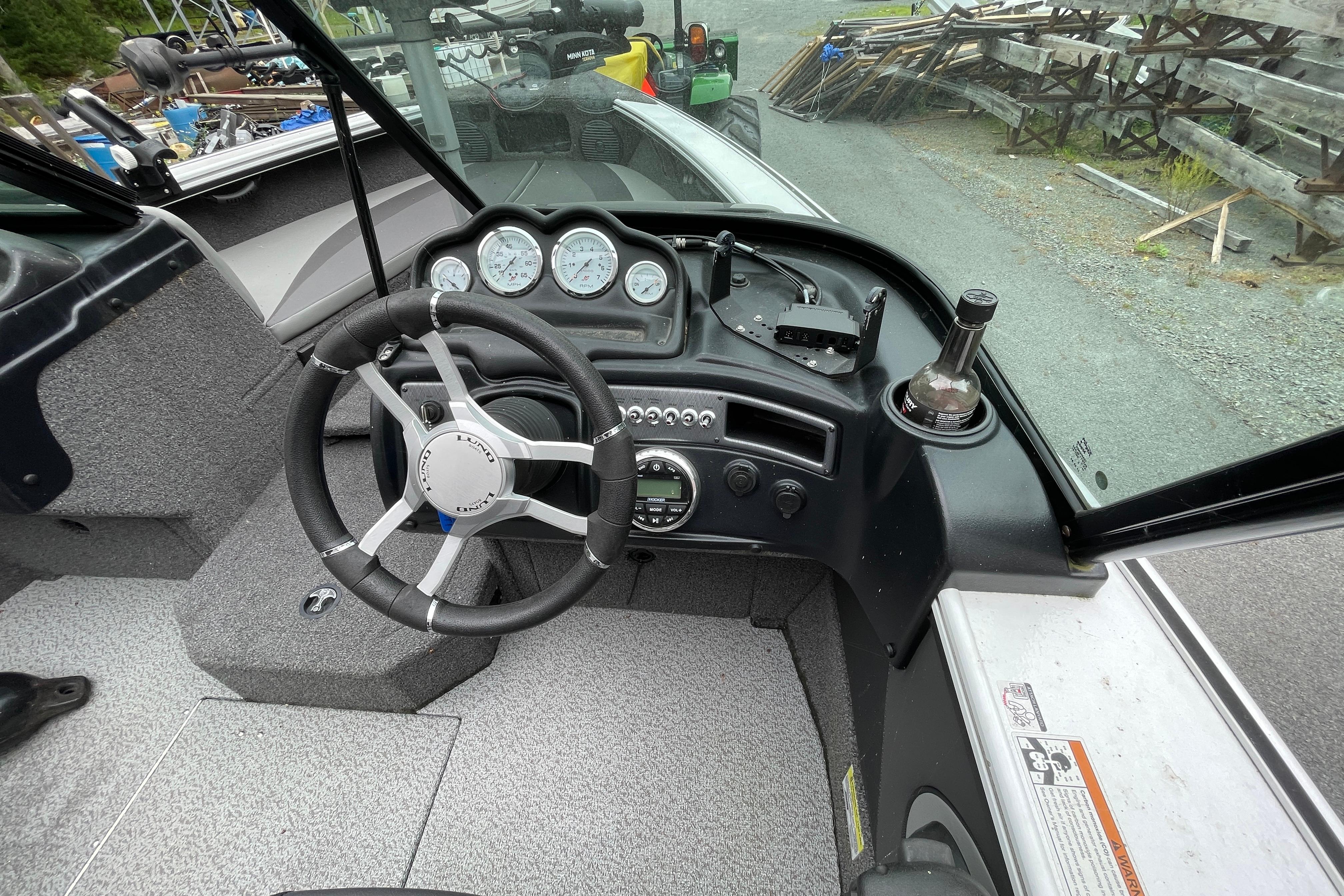 2022 Lund 1875 Crossover XS boat dashboard with steering wheel and gauges.