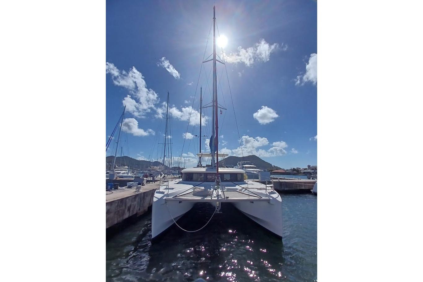 2020 Lagoon 46 catamaran docked under clear blue sky.