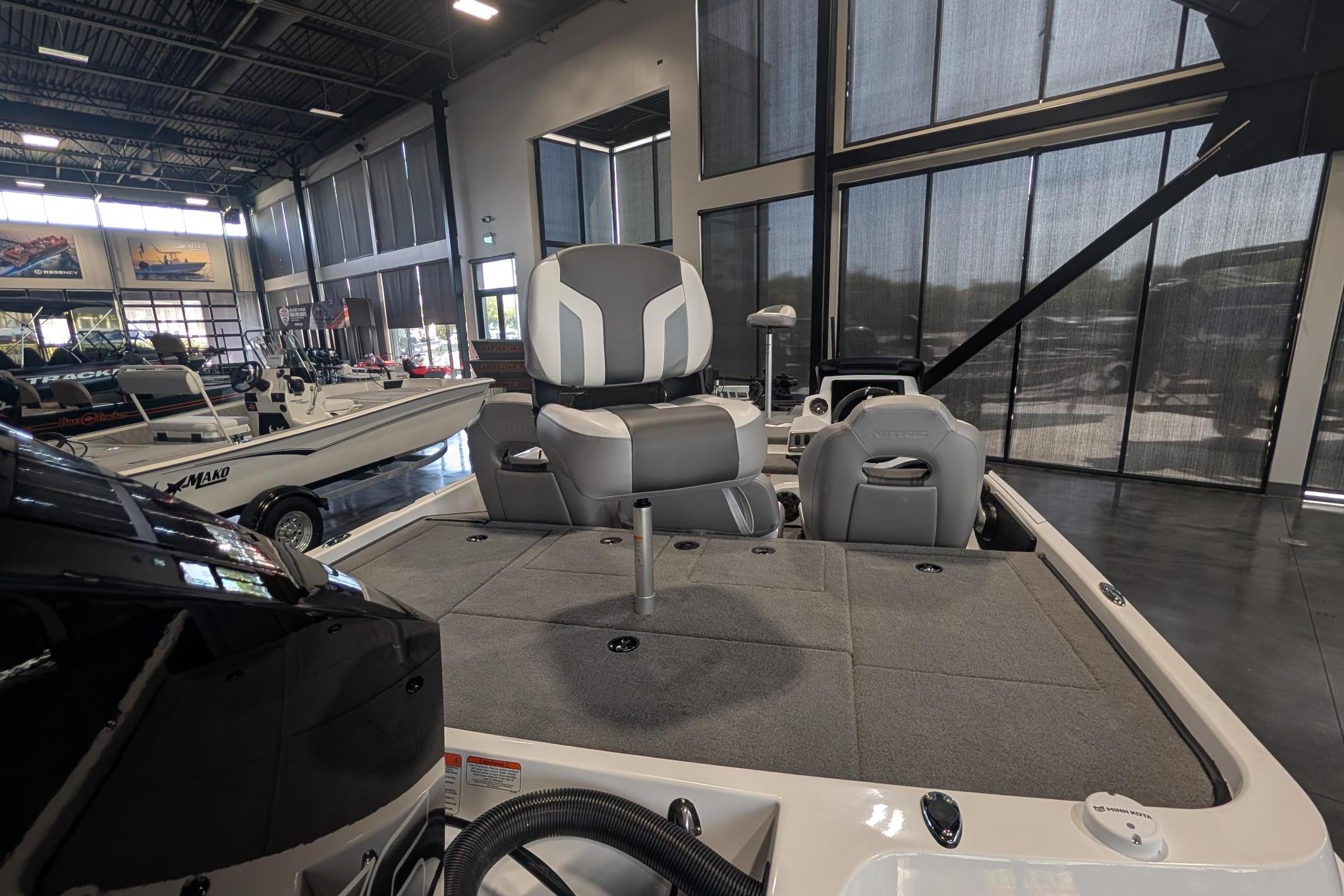 2026 Nitro Z19 XL Pro boat interior with gray seating in showroom.