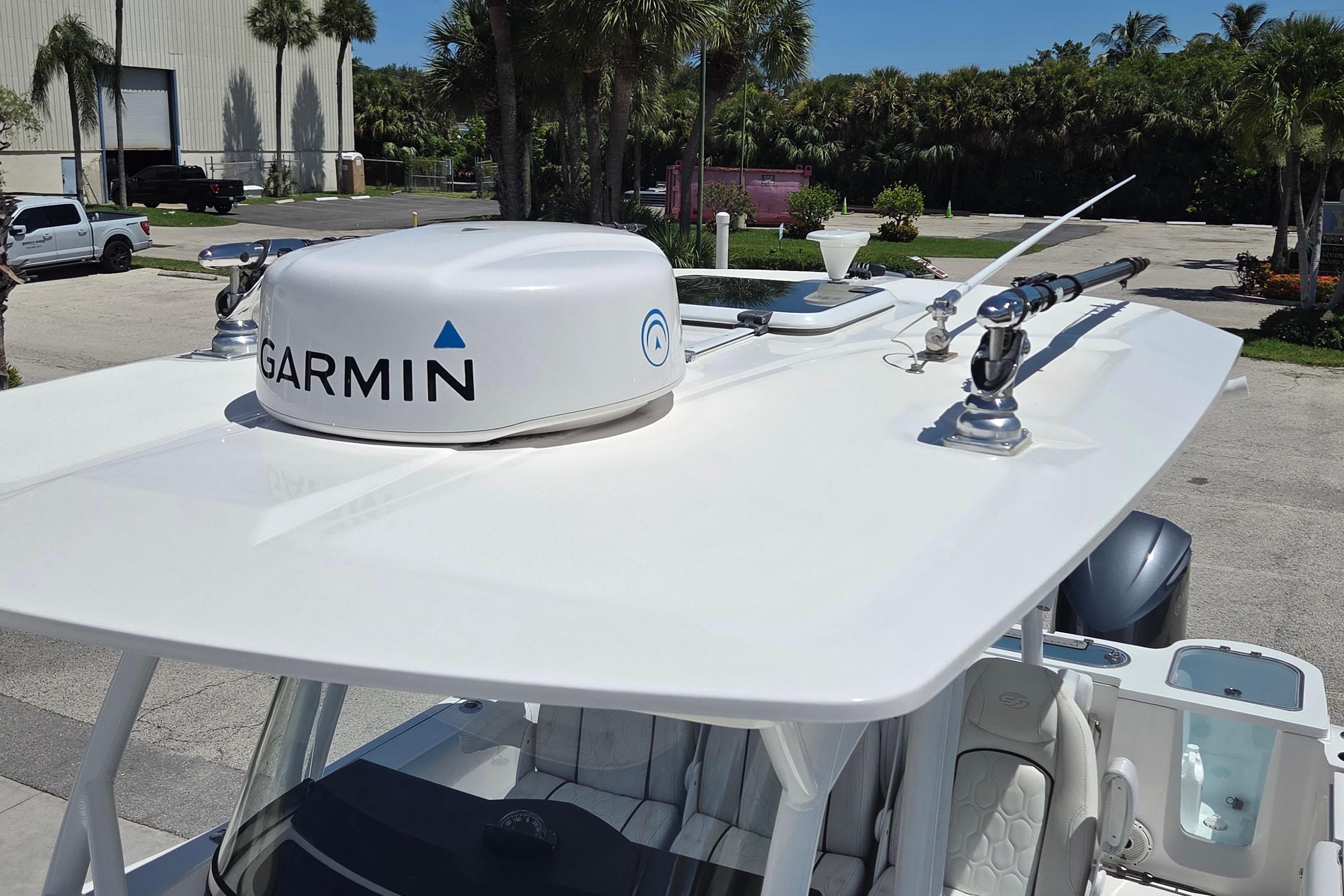 2021 Sea Fox 328 Commander boat with Garmin radar, parked near palm trees.