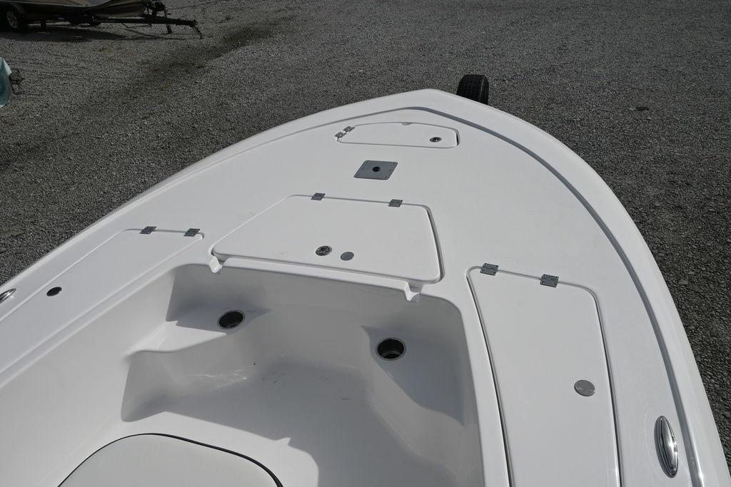 2026 Tidewater 1910 Bay Max boat deck with storage compartments, shown on gravel surface.