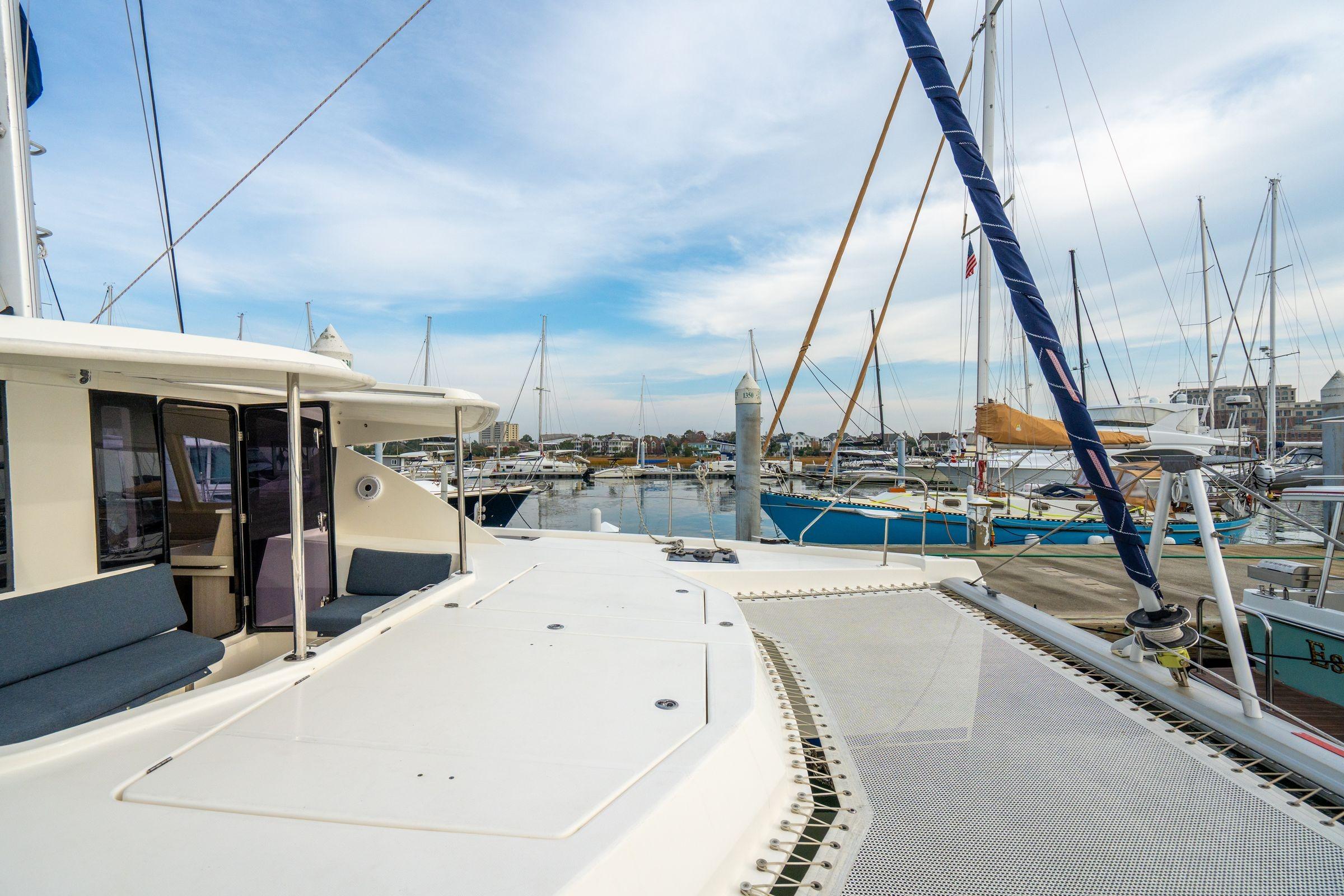 Leopard 48 catamaran docked at marina, showcasing spacious deck and modern design.