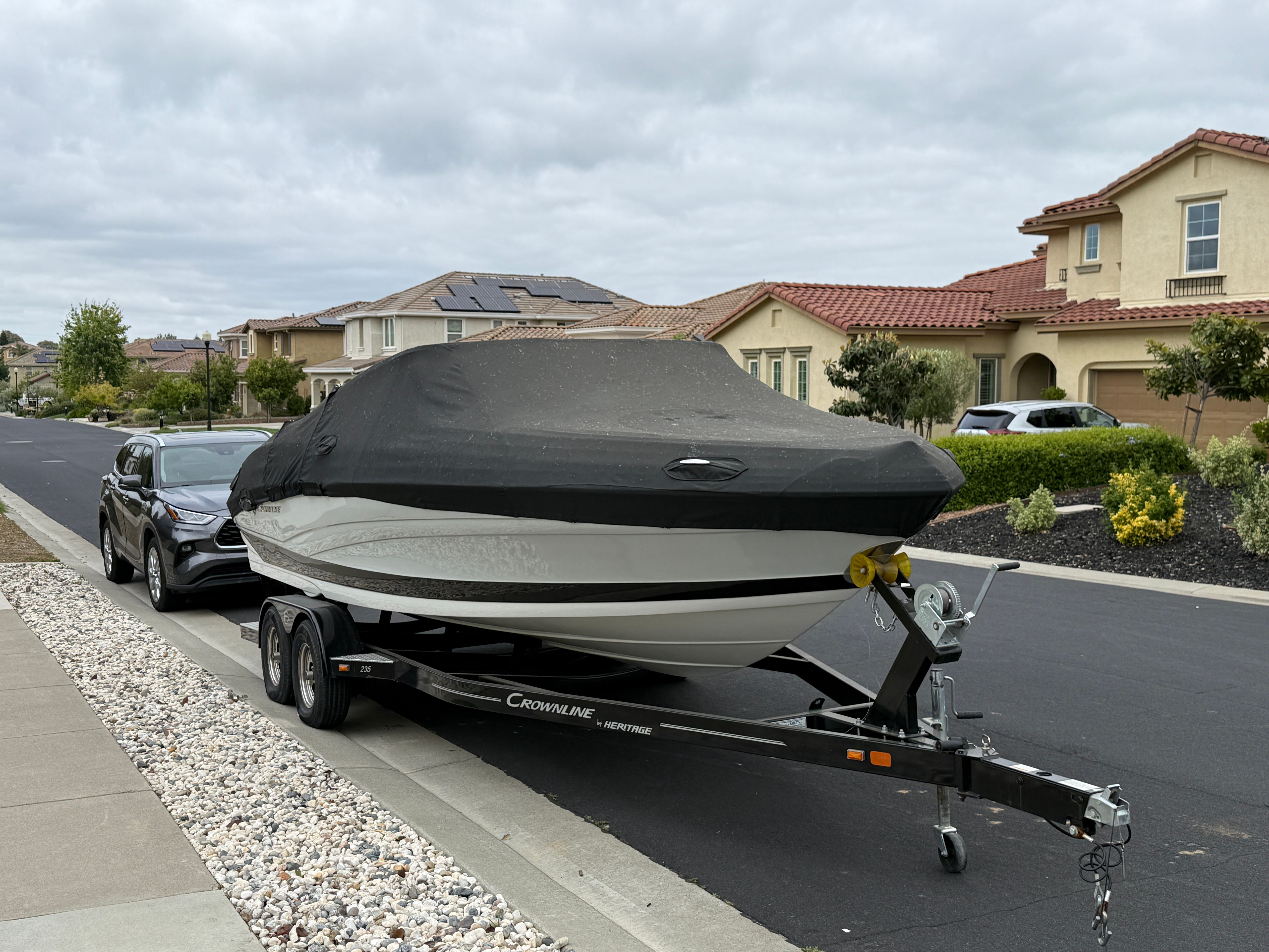 2019 Crownline 235 SS boat on trailer in residential street.