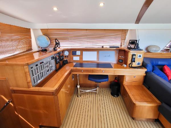 2009 Catana 65 yacht interior with navigation station and wooden furnishings.
