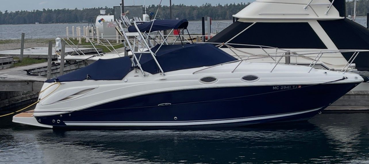 2006 Sea Ray 270 Amberjack boat docked at marina.