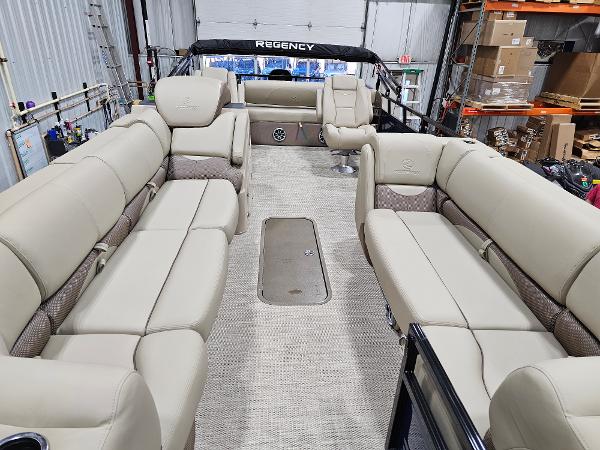 2024 Regency 250 DL3 pontoon boat interior with beige seating.