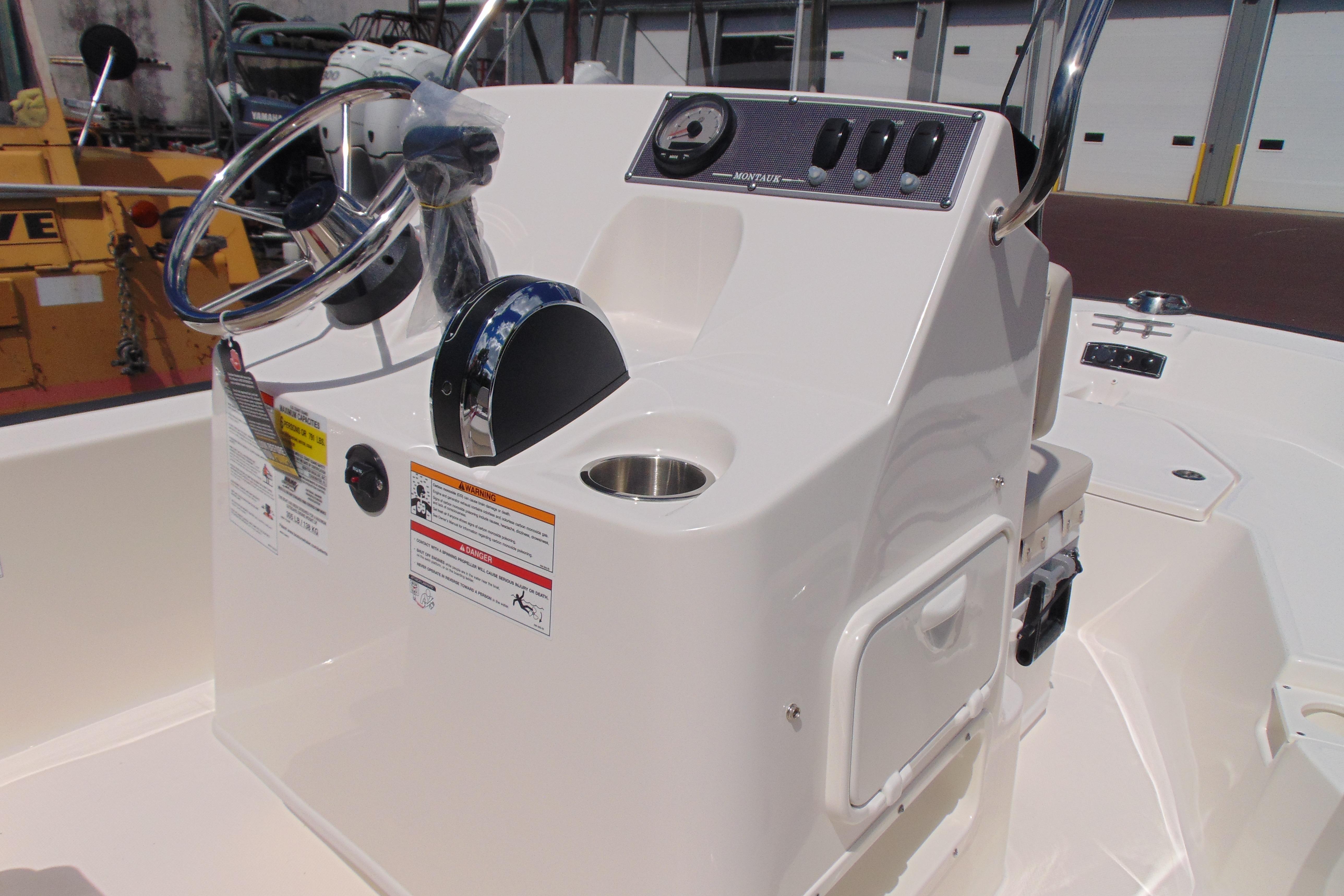 2026 Boston Whaler 150 Montauk boat console with steering wheel and controls.