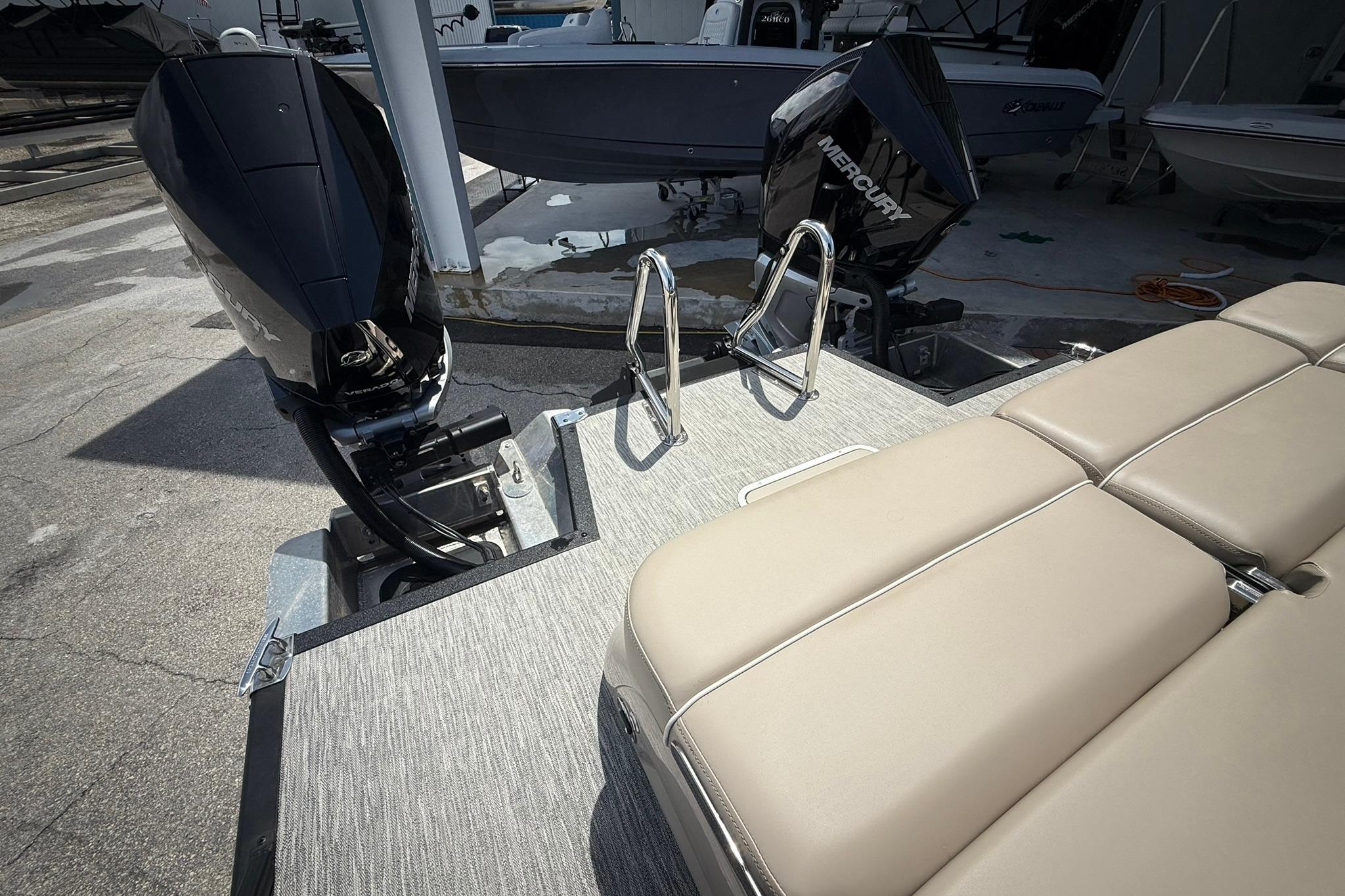 2026 Bennington 27 QSBAT2 boat with Mercury outboard engines and beige seating.