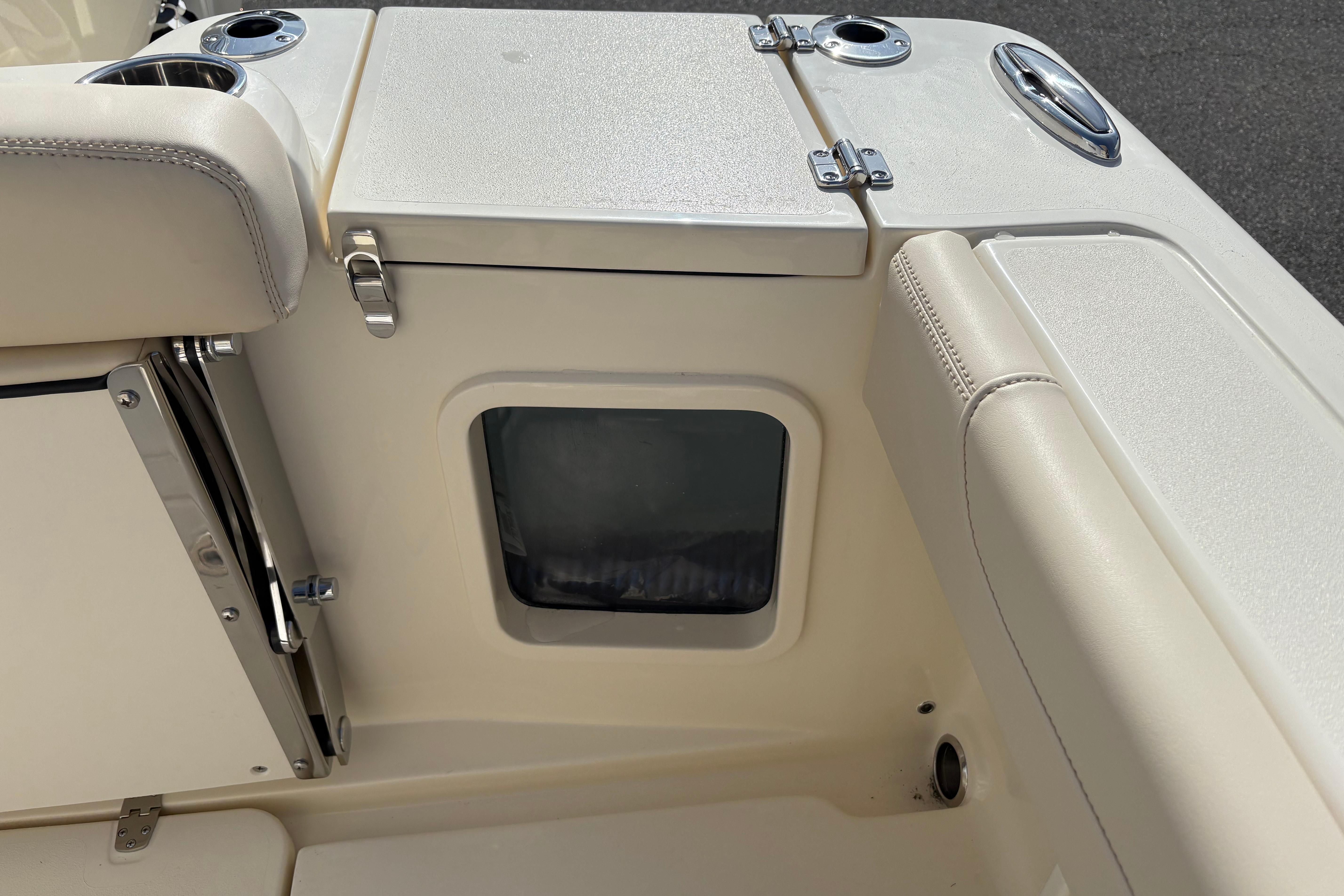 Interior view of a 2026 Scout 220 XSF boat, featuring seating and storage compartments.