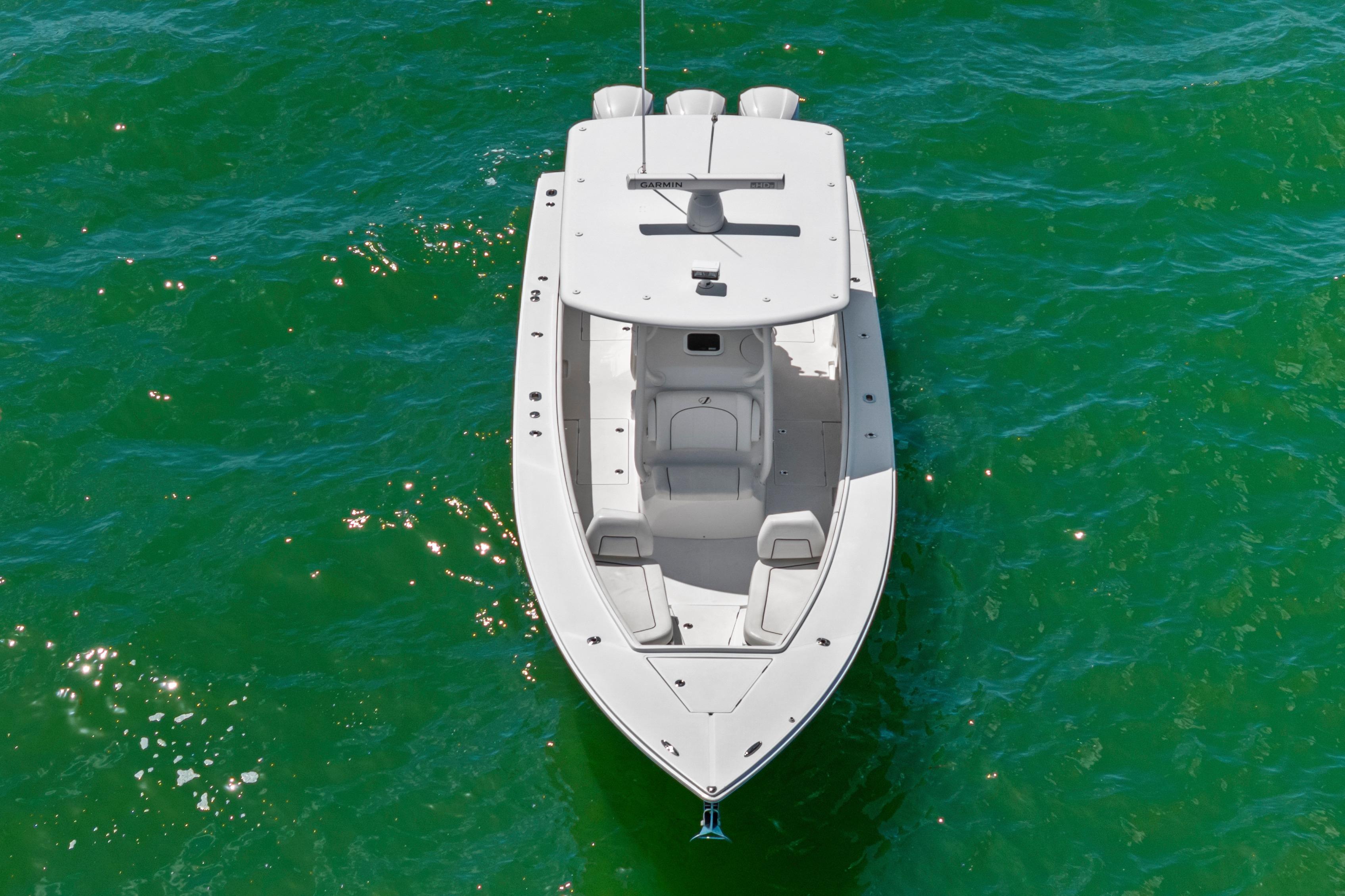 Overhead view of a 2015 Jupiter 34 HFS boat on vibrant green water.