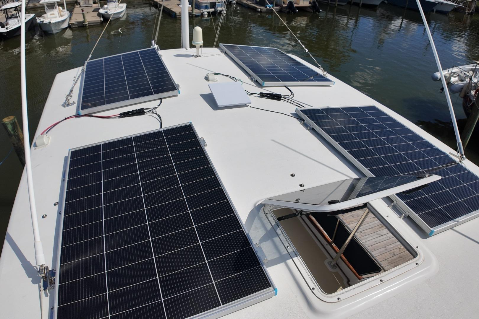Solar panels on a 1978 Grand Banks 42 Classic yacht roof at a marina.