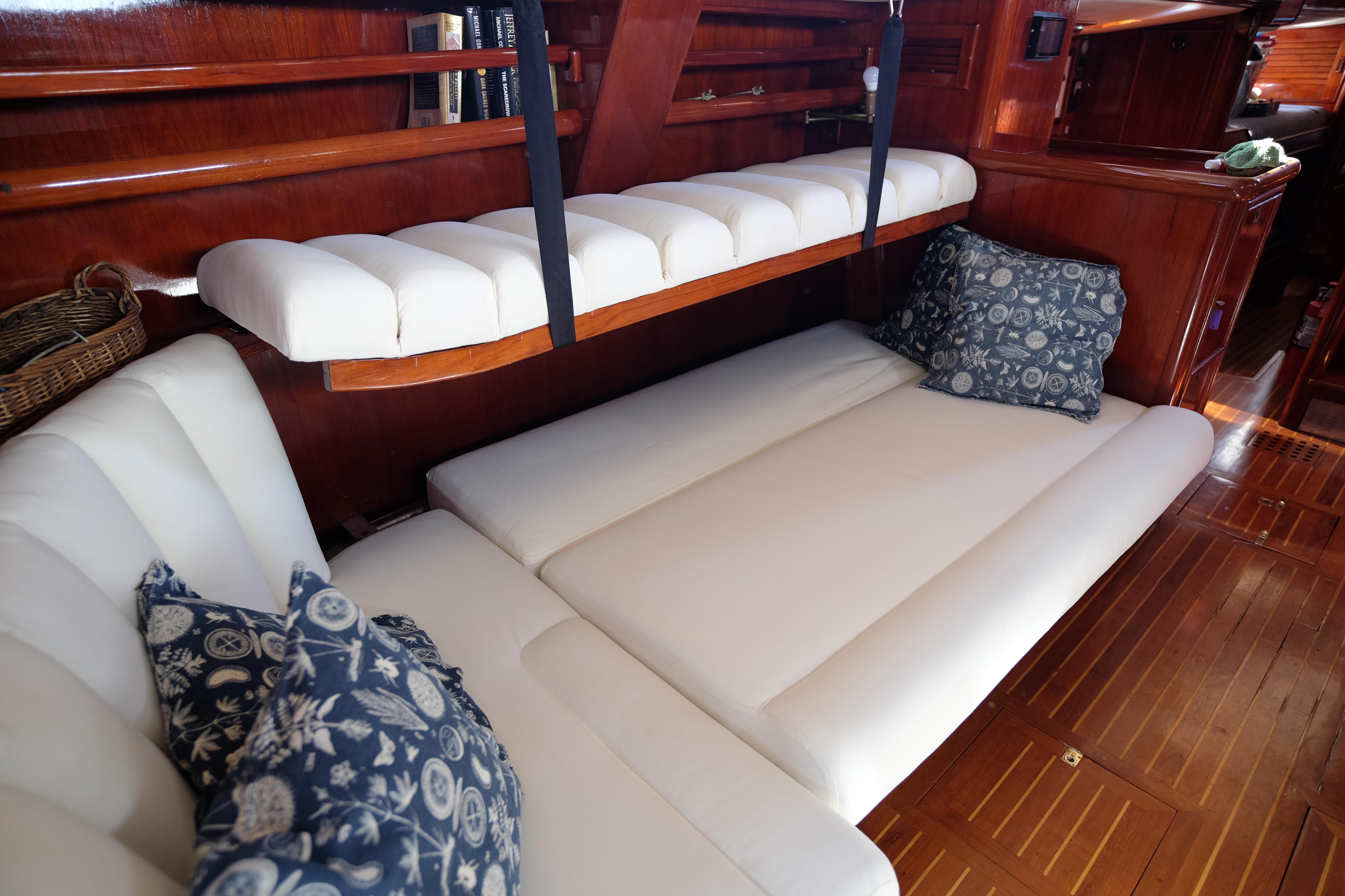 Luxurious interior of a 1988 Cooper 60 yacht with plush seating and decorative pillows.