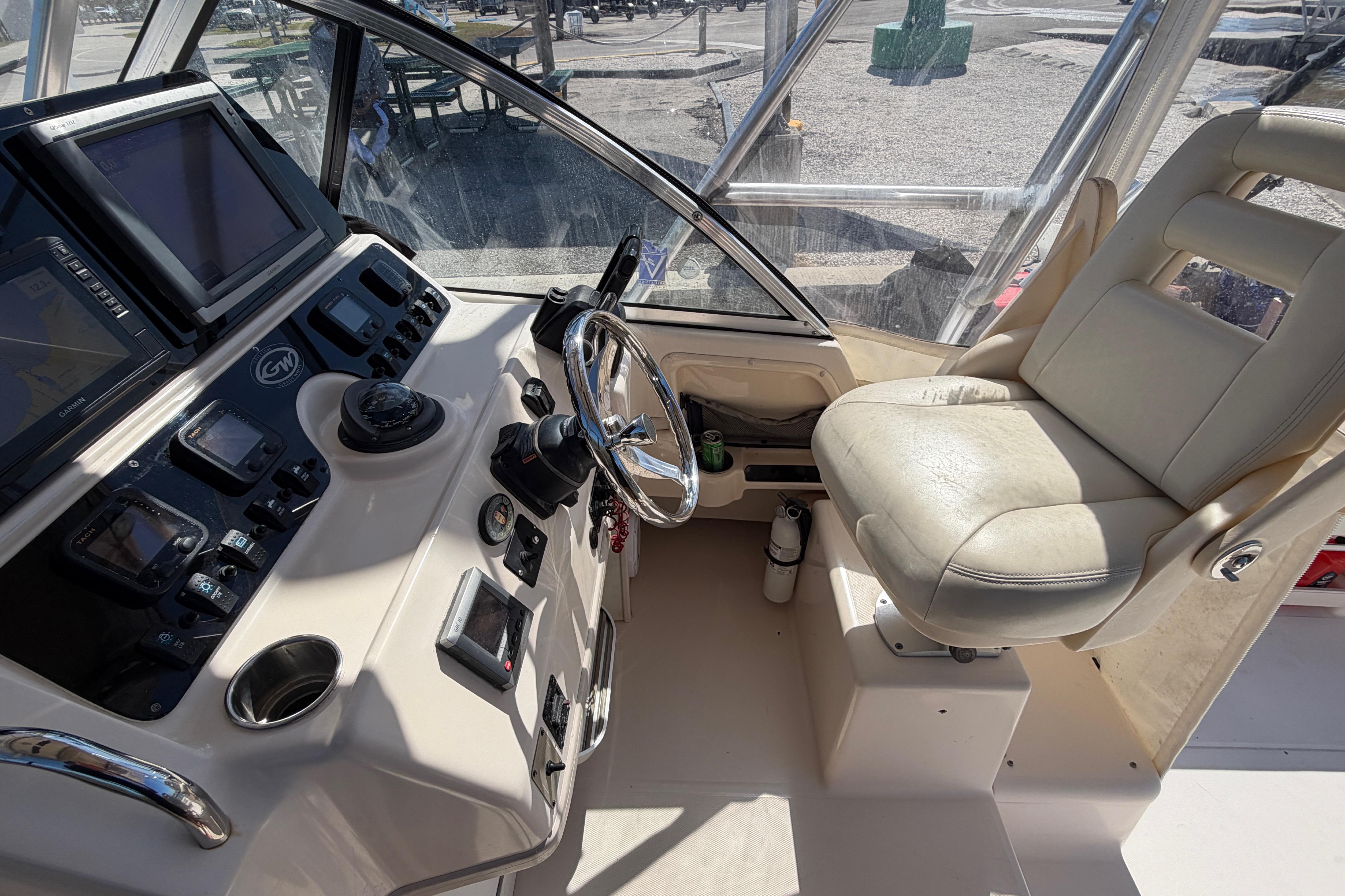 2006 Grady-White Sailfish 282 helm with navigation equipment and captain's chair.