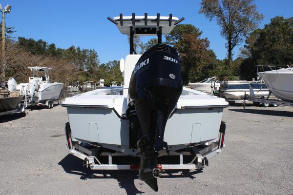 2025 East Cape 25 Open boat with Suzuki 300 engine on trailer, parked outdoors.