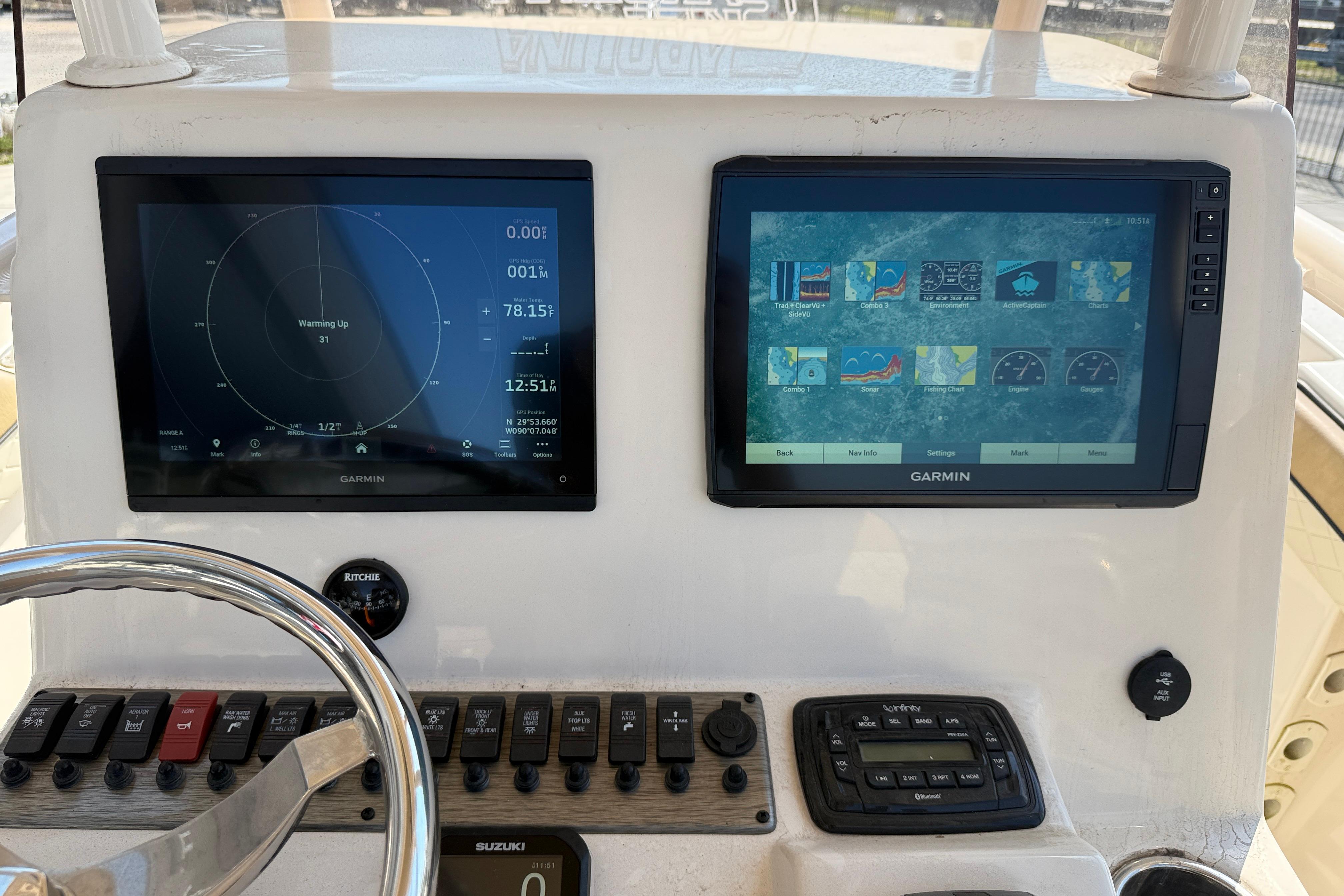2023 SeaChaser 24 HFC boat dashboard with dual Garmin displays and control panel.
