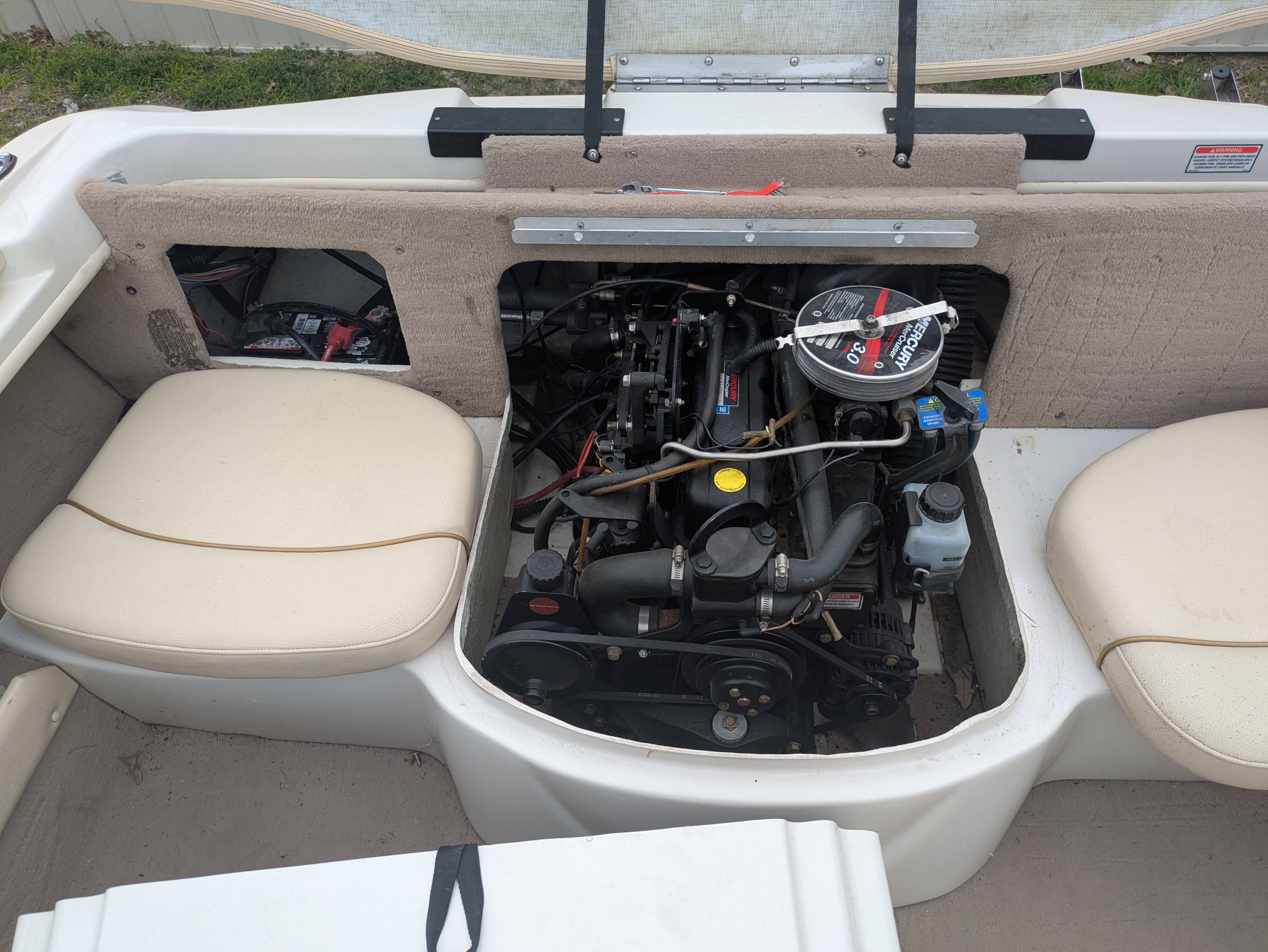 An open engine compartment of a 2000 Sea Ray 185 Bow Rider boat.