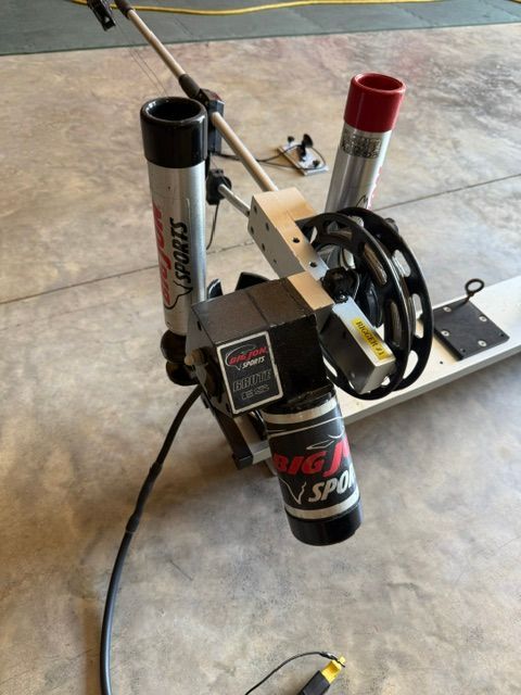 A fishing rod holder labeled "Big Jon Sports" is mounted on a boat.