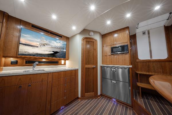 Interior of 2025 Albemarle 36 Express yacht with modern kitchen and wood finishes.