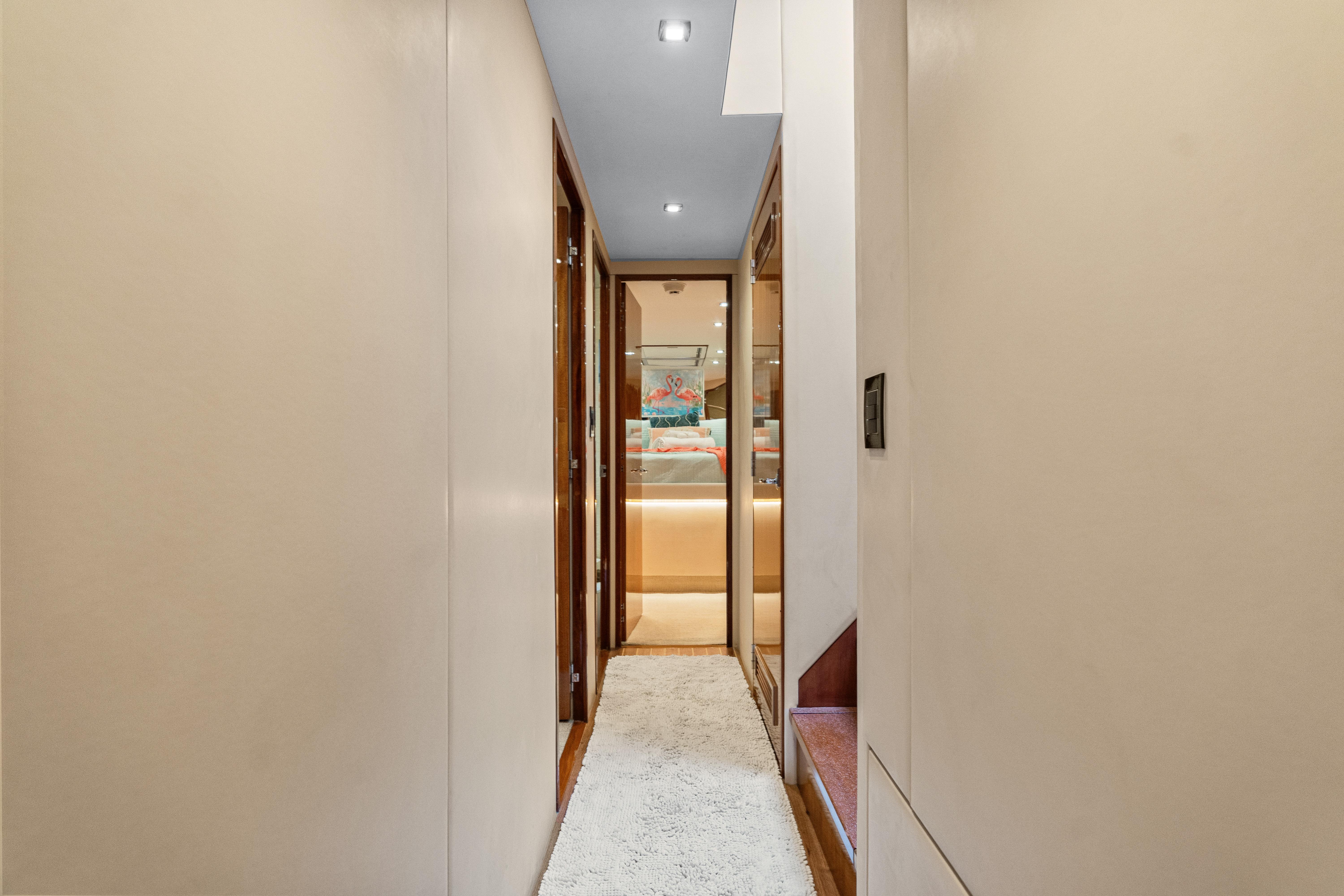 Hallway inside 2008 Hatteras 64 Motor Yacht, featuring modern design and ambient lighting.