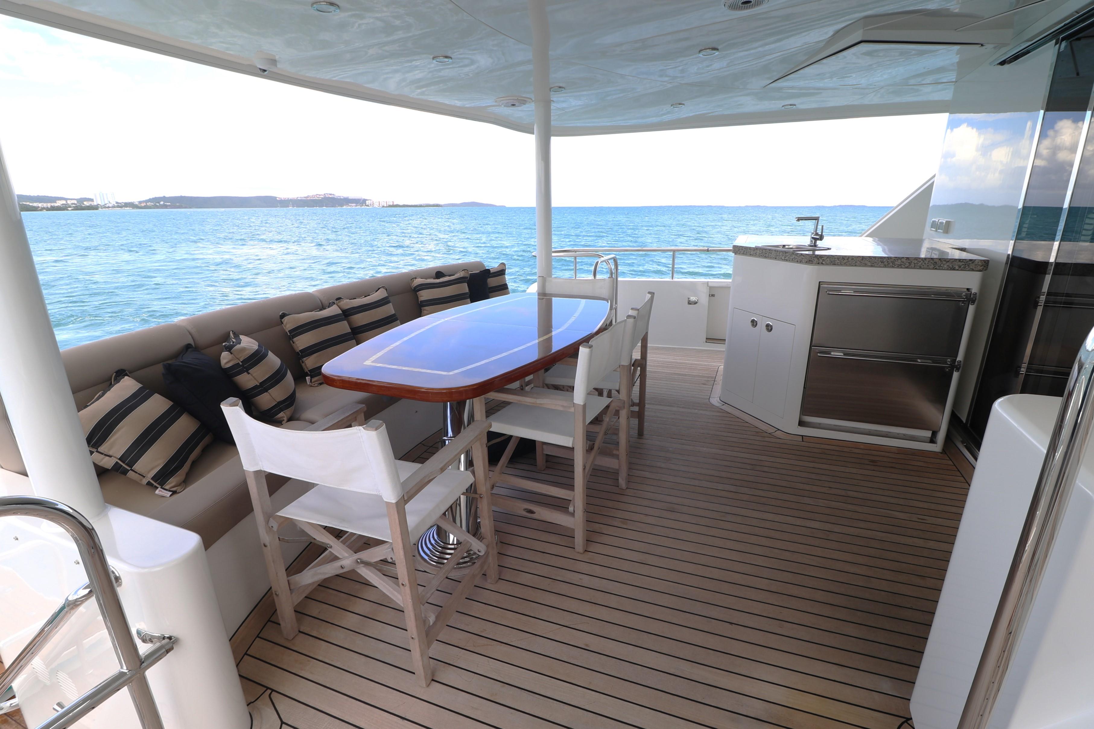 2013 Cheoy Lee Bravo yacht deck with dining area and ocean view.
