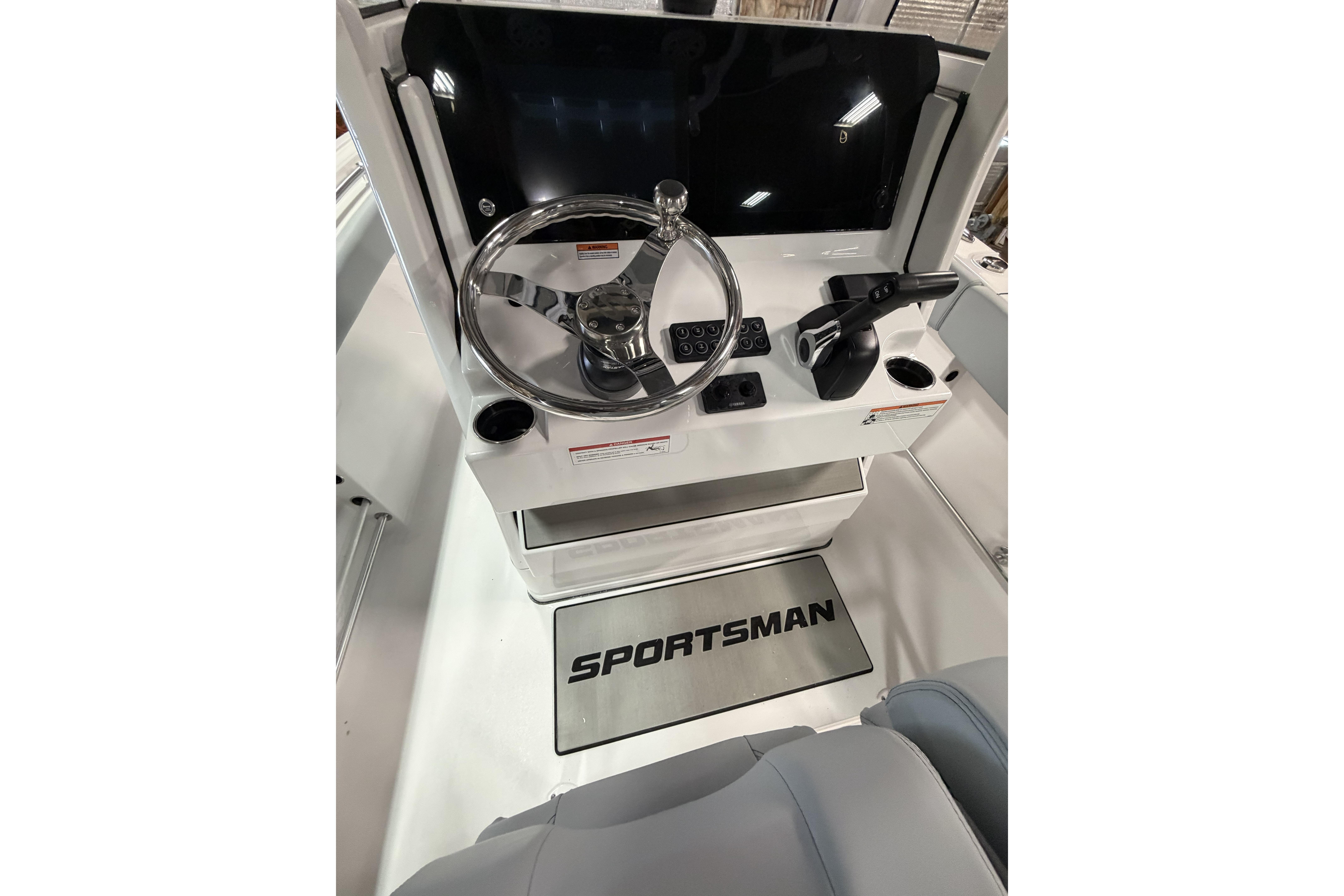 2026 Sportsman Open 232 Center Console boat dashboard with steering wheel and controls.