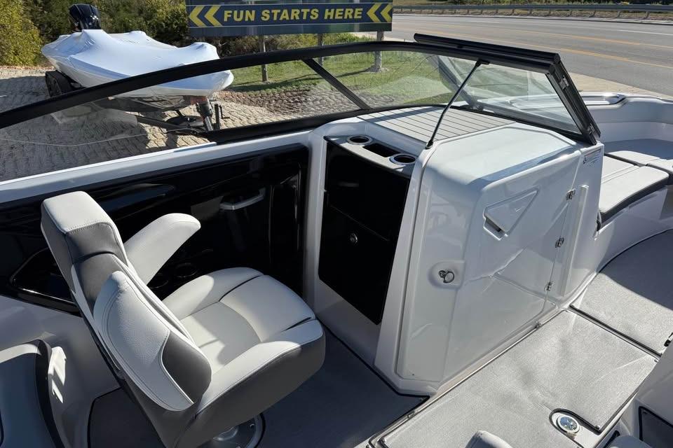 2026 Yamaha Boats AR250 interior with captain's chair and dashboard, showcasing sleek design.