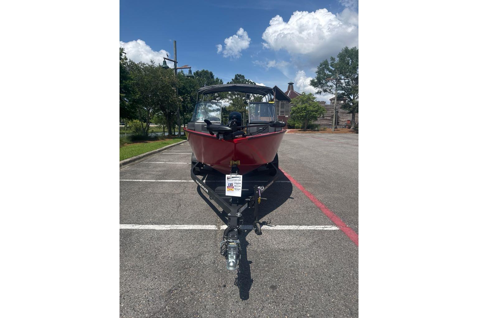 2026 Tracker Pro Guide V-175 Combo boat on trailer in parking lot.