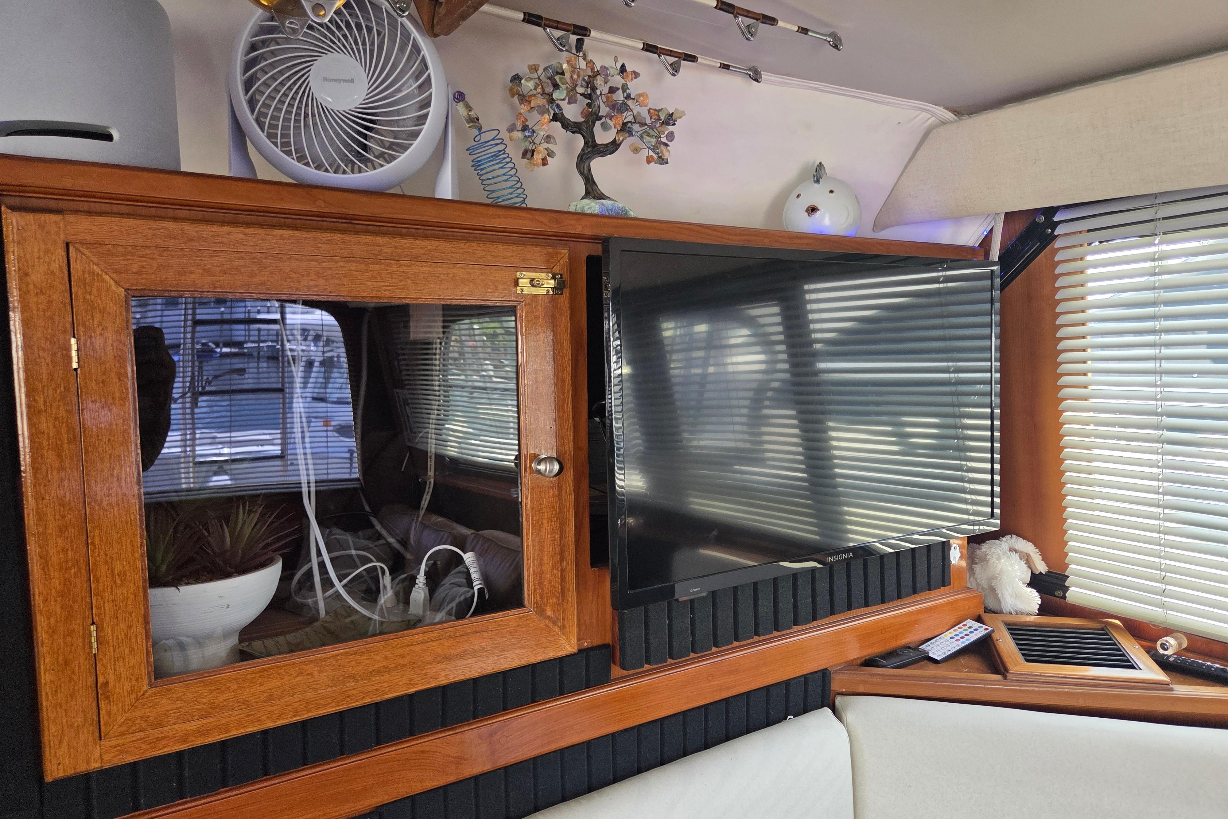 Interior of 1990 Egg Harbor Golden Egg 42 yacht with TV and wooden cabinet.