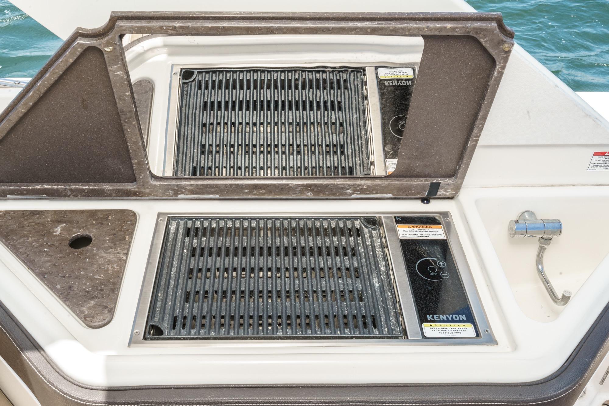 Outdoor grill on 2018 Sea Ray SLX 310 boat, featuring Kenyon cooking surface.