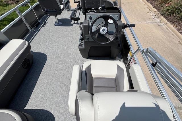 2026 Sun Tracker Bass Buggy 16 XL Select pontoon boat interior with steering console and seating.