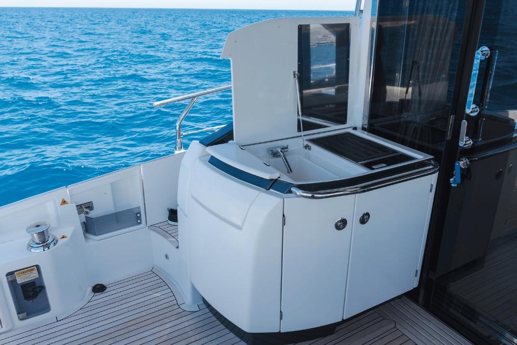 Outdoor kitchen on 2020 Azimut 60 yacht with ocean view.