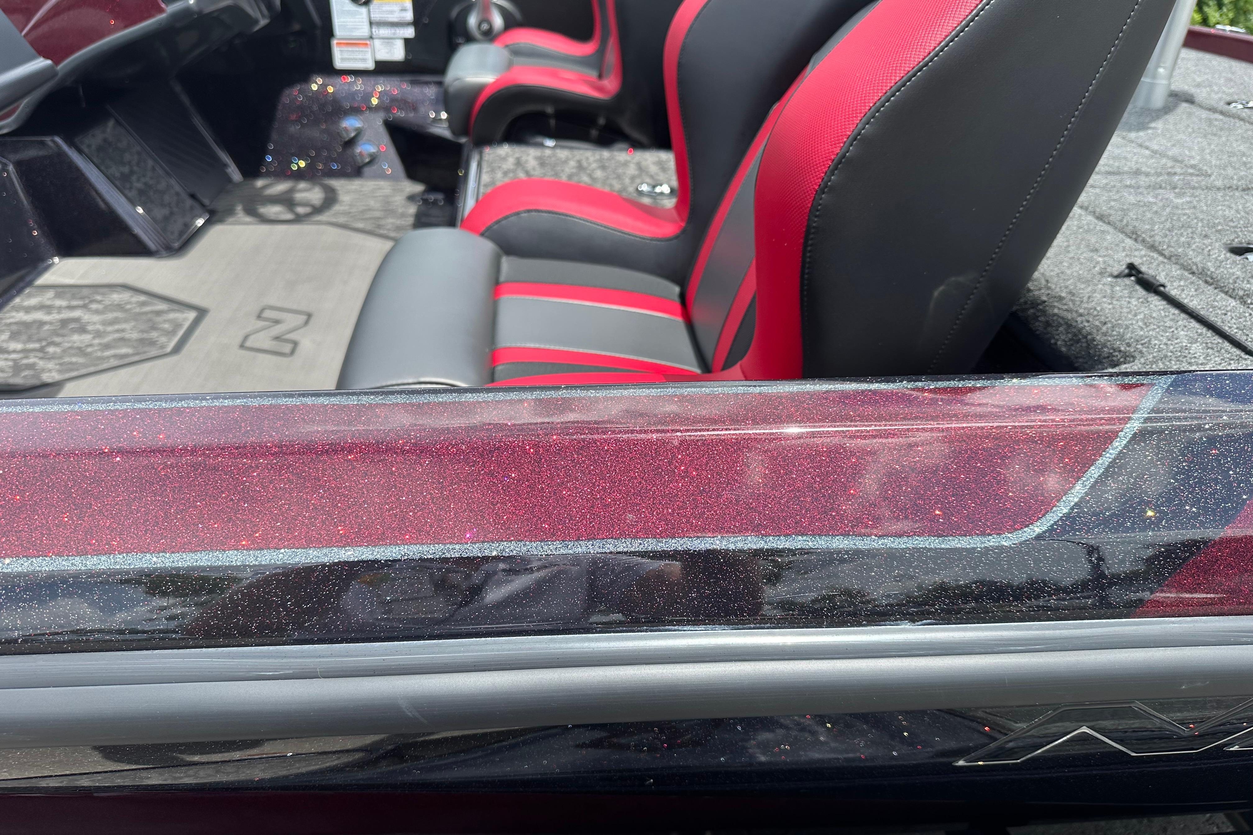 2026 Nitro Z21 XL boat interior with red and black seats, glitter finish.