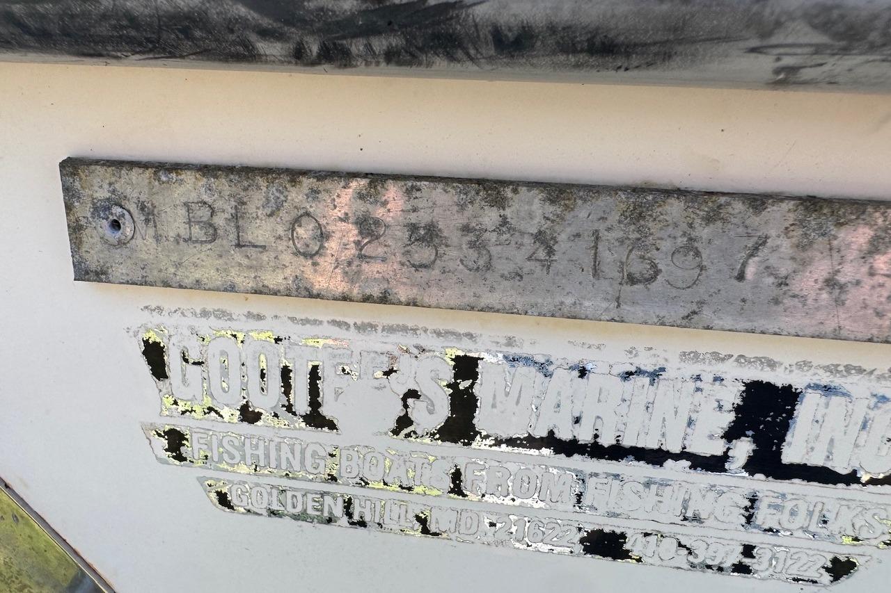 1997 Maycraft 23 boat identification plate with serial number and faded marine label.