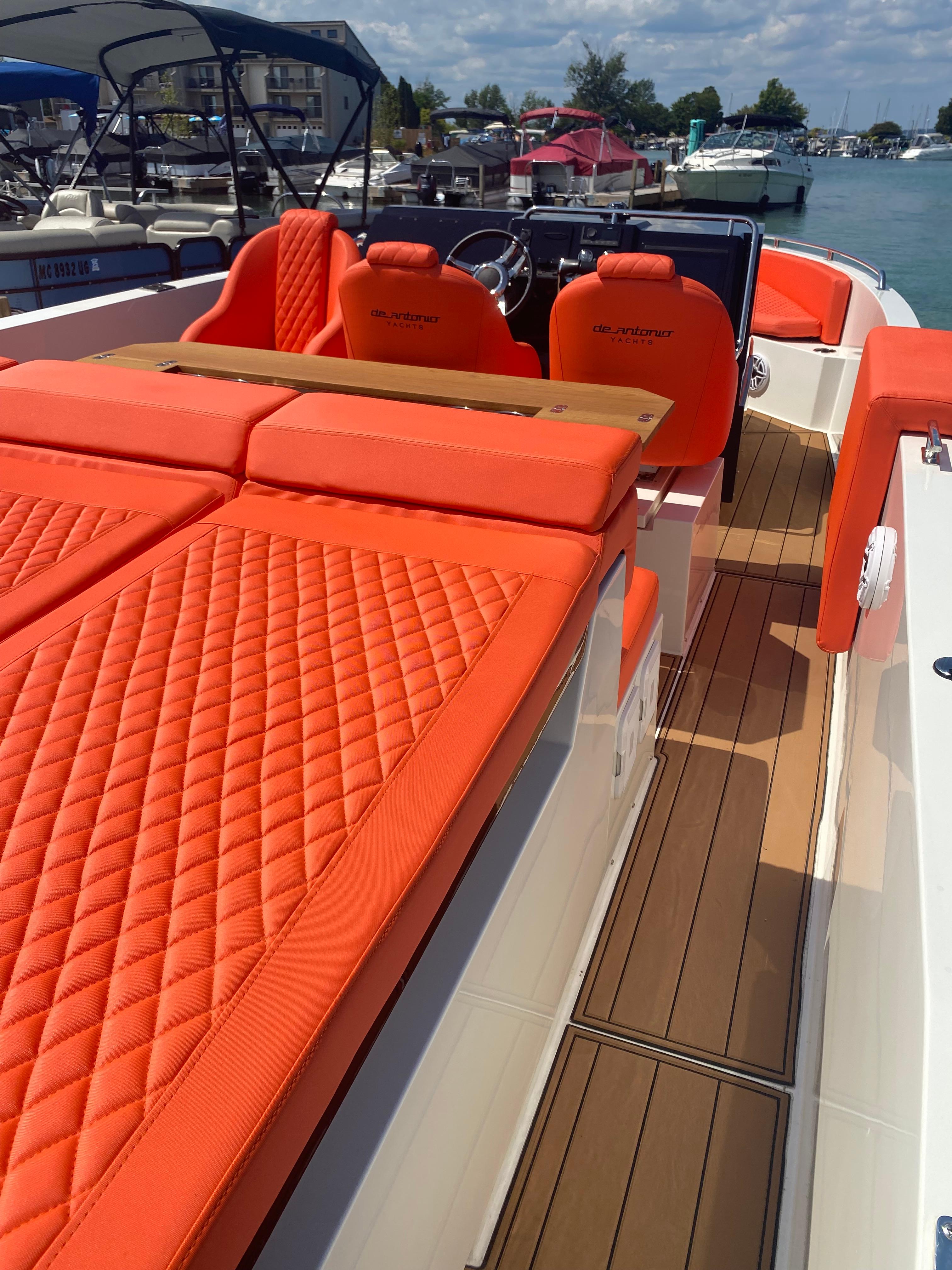2020 De Antonio Yachts D 28 with vibrant orange seating and sleek deck design.
