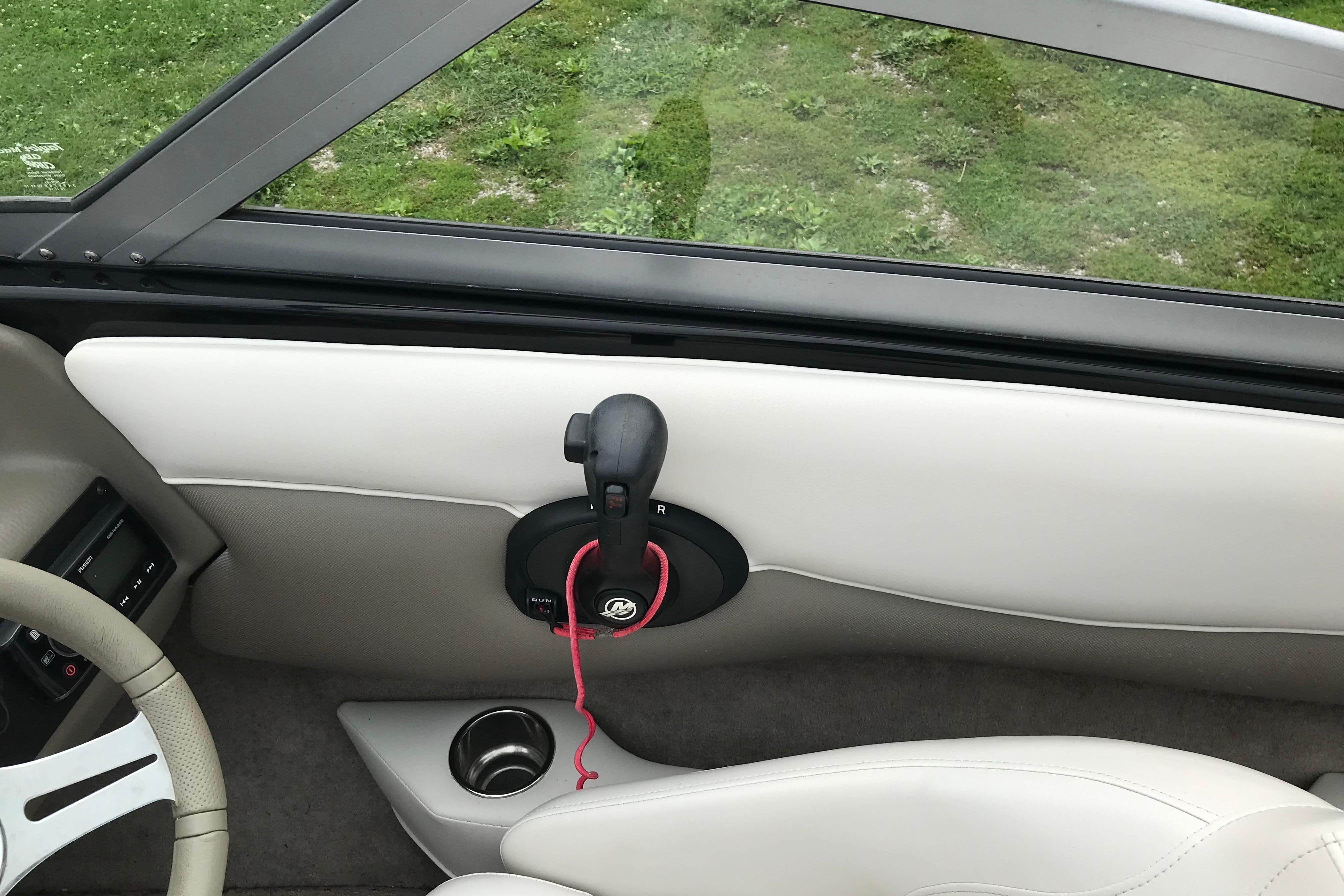 Interior of 2015 Crownline 18 SS boat showing steering wheel and throttle control.