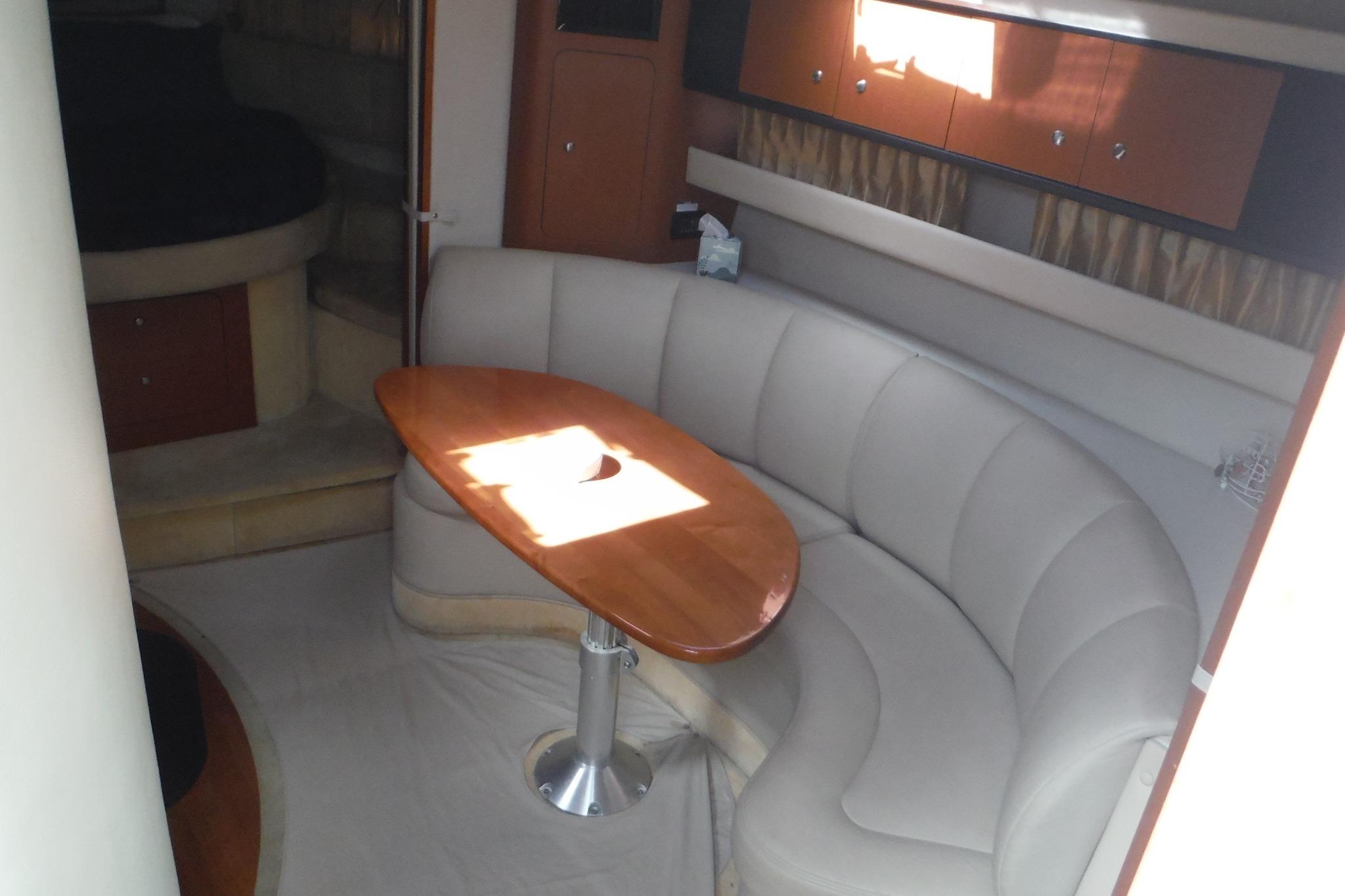 Interior of 2005 Chaparral Signature 350 yacht with curved seating and wooden table.