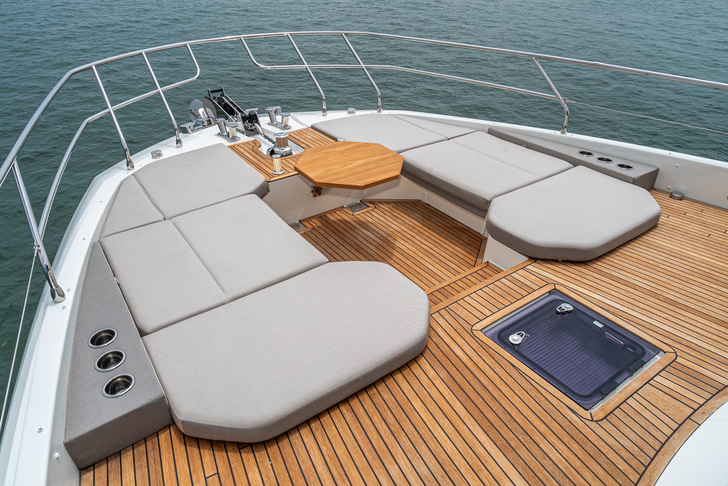Luxurious 2024 Prestige X60 yacht deck with cushioned seating and wooden flooring.