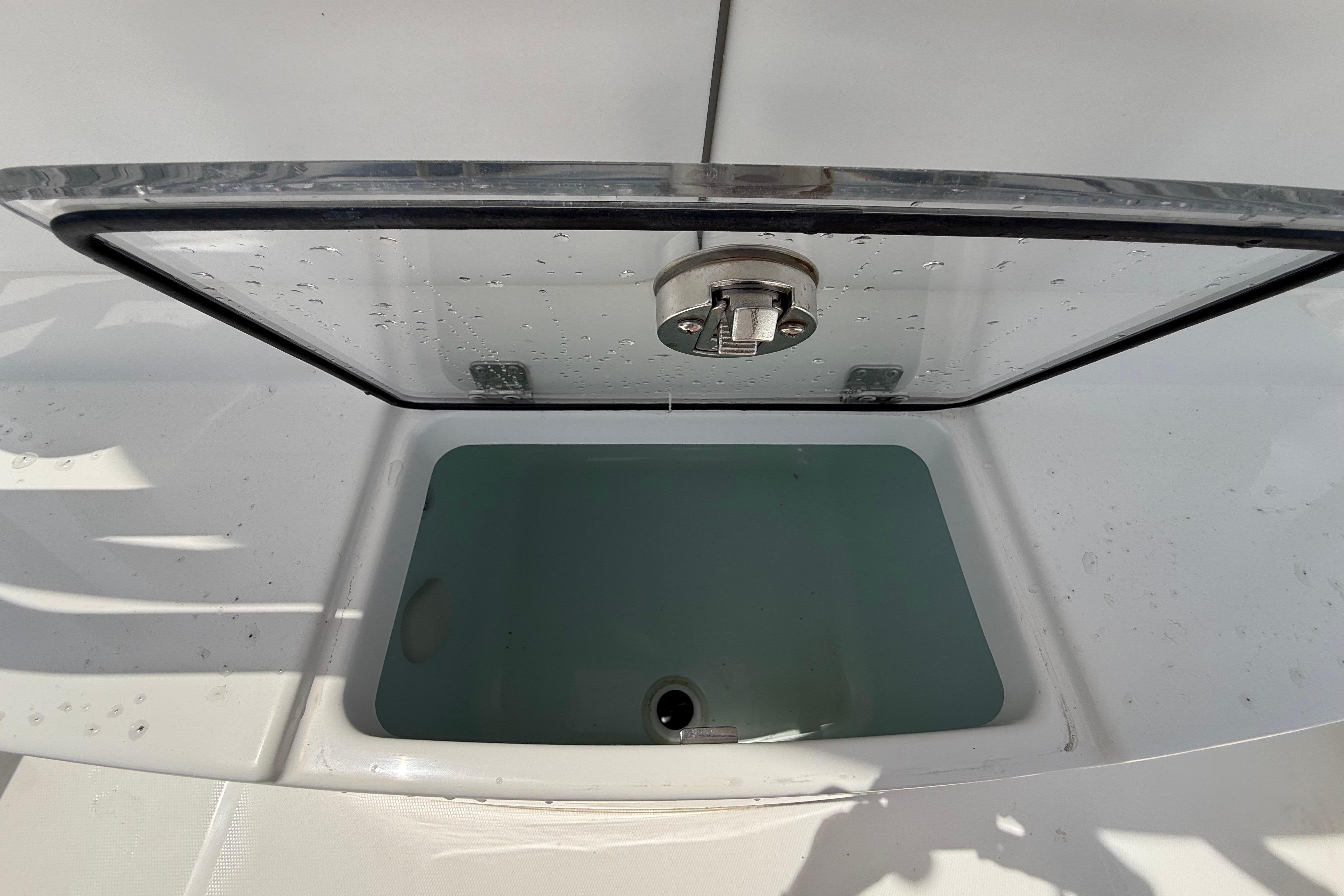 Open storage compartment on 2019 Regulator 26XO boat, showing interior details.